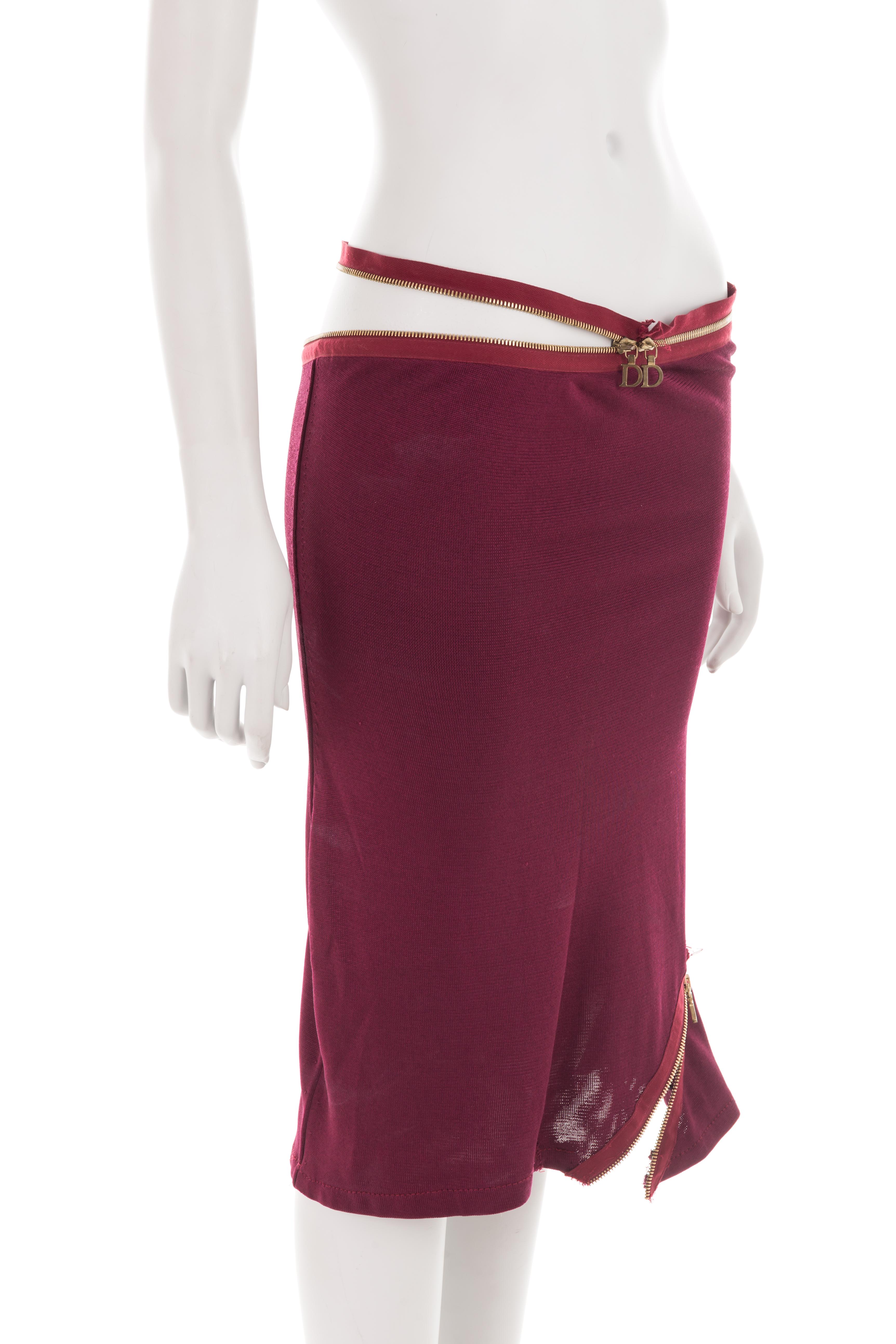 - Christian Dior by John Galliano
- Spring-summer 2001 collection
- Sold by Gold Palms Vintage
- Viscose mix burgundy pencil skirt
- Gold asymmetric zippers
- Adjustable fit
- Size: UK 8 - US 4