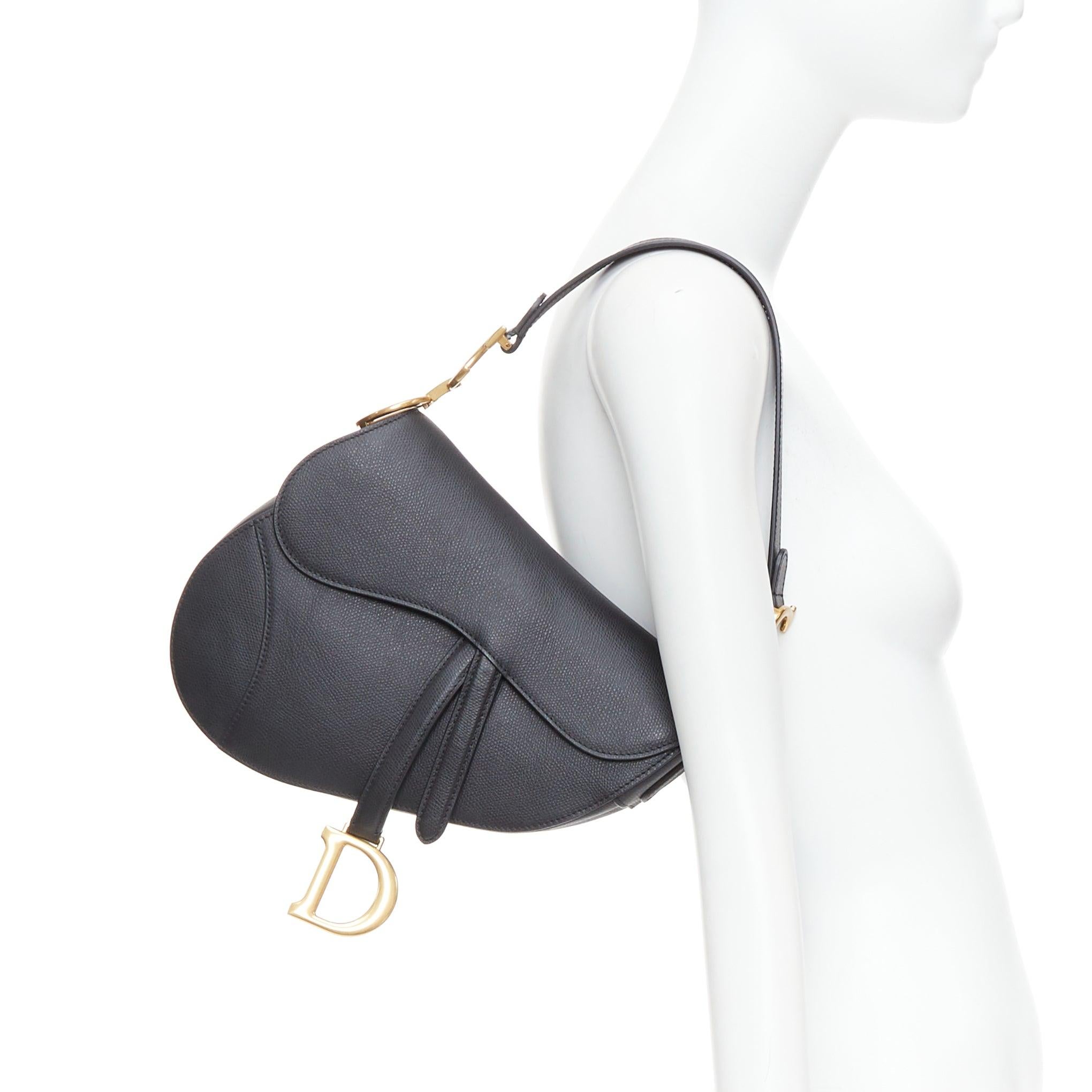 CHRISTIAN DIOR Saddle black textured leather gold CD shoulder bag
Reference: LNKO/A02529
Brand: Dior
Designer: Maria Grazia Chiuri
Model: Saddle
Material: Leather
Color: Black, Gold
Pattern: Solid
Closure: Flap
Lining: Black Microsuede
Extra