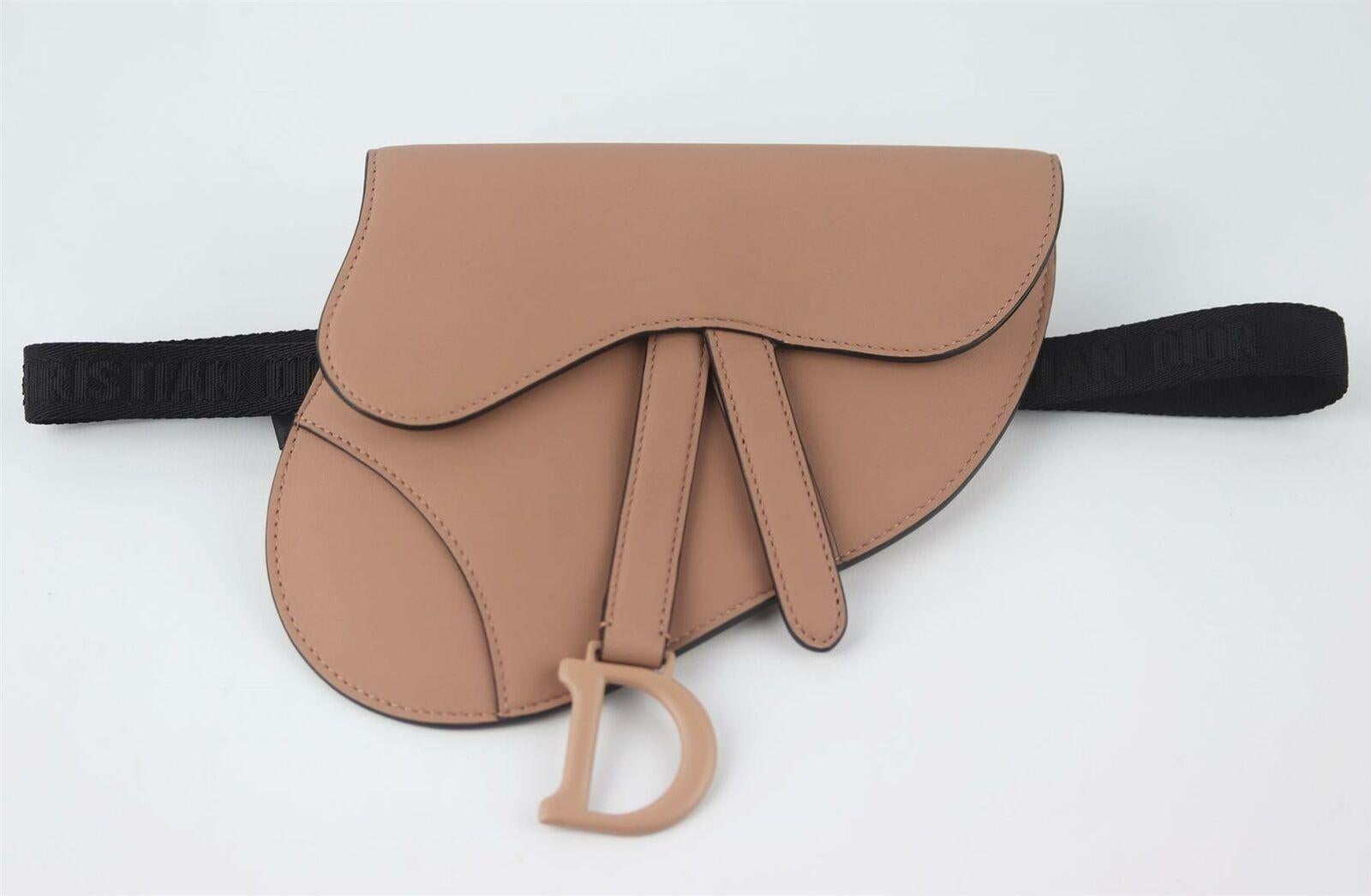 Made in Italy, this beautiful Christian Dior 'Saddle' belt bag has been made from blushed powdder matte calfskin exterior with matching blushed suede interior, this piece is decorated with Dior's pink matte finish hardware on the front and back and