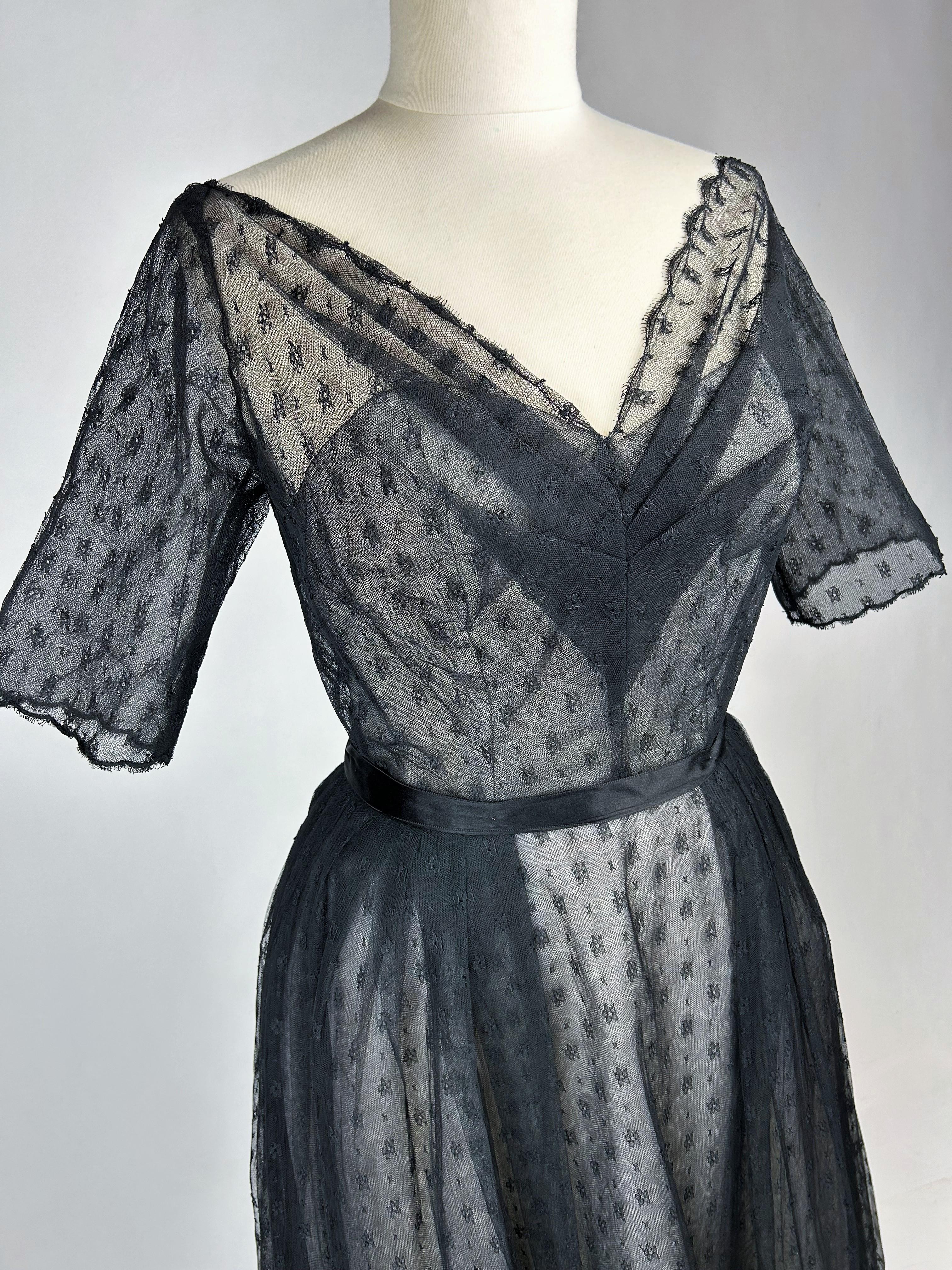 Autumn Winter 1960 Collection
France

Christian Dior/ Yves Mathieu Saint Laurent (attributed to) long evening dress in black Calais lace, Almaviva model.  White whalebone bustier with large neckline covered with embroidered tulle, raglan sleeves,