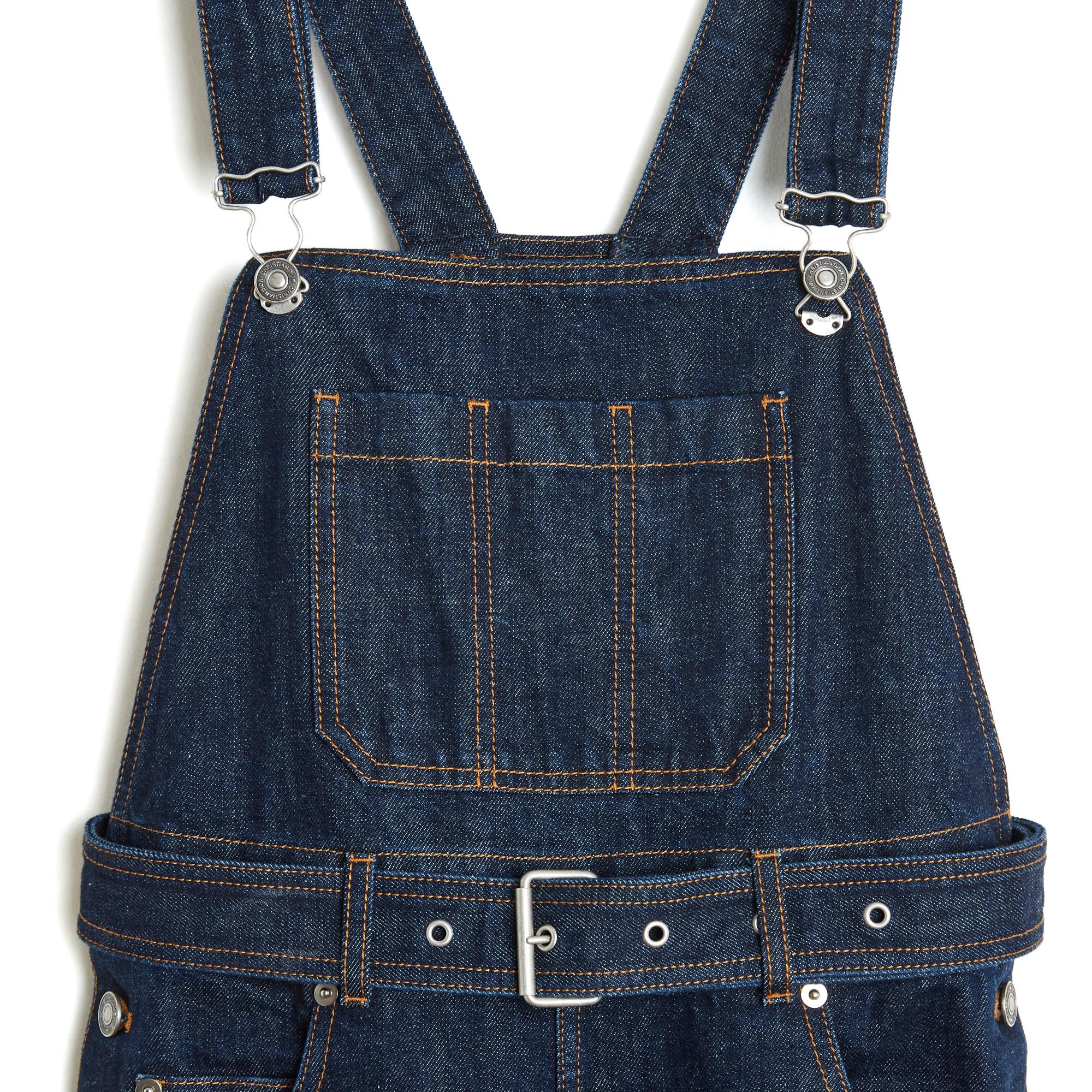 Christian Dior dungarees by Maria Grazia Chiuri (between 2017 and 2020) in thick raw denim, with adjustable straps, high waist closed by 3 logo buttons on each side and a matching belt with pin buckle held on 5 belt loops, wide leg, patch pocket on