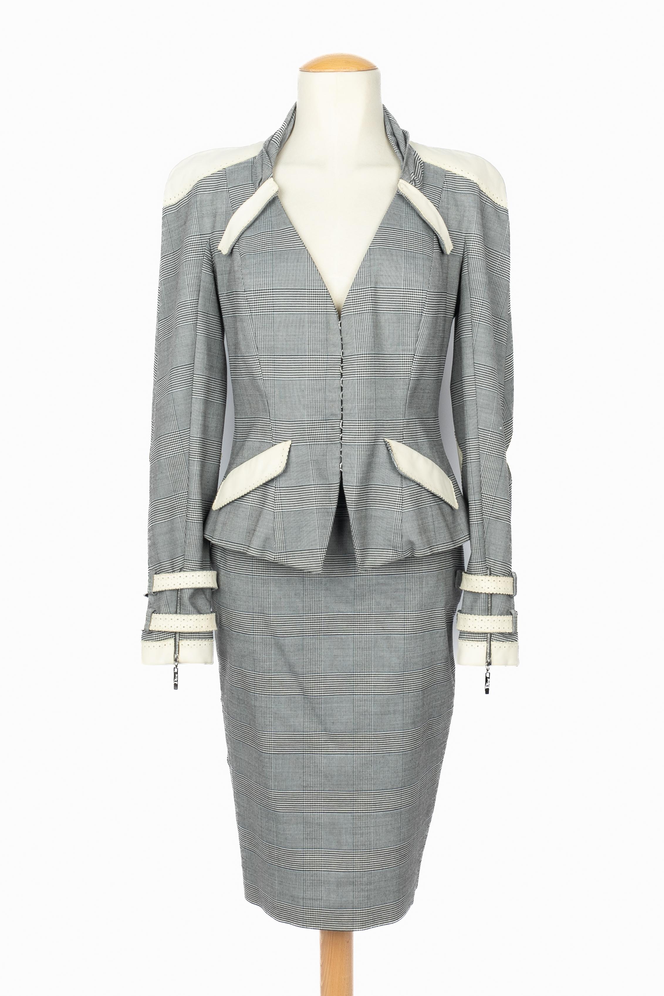 DIOR - (Made in France) Prince-of-Wales-check pattern blended cotton set composed of a jacket and a skirt, ornamented with lamb leather and off-white openwork. Size 40FR indicated for the jacket and 38FR for the skirt. 2004 Spring-Summer Collection