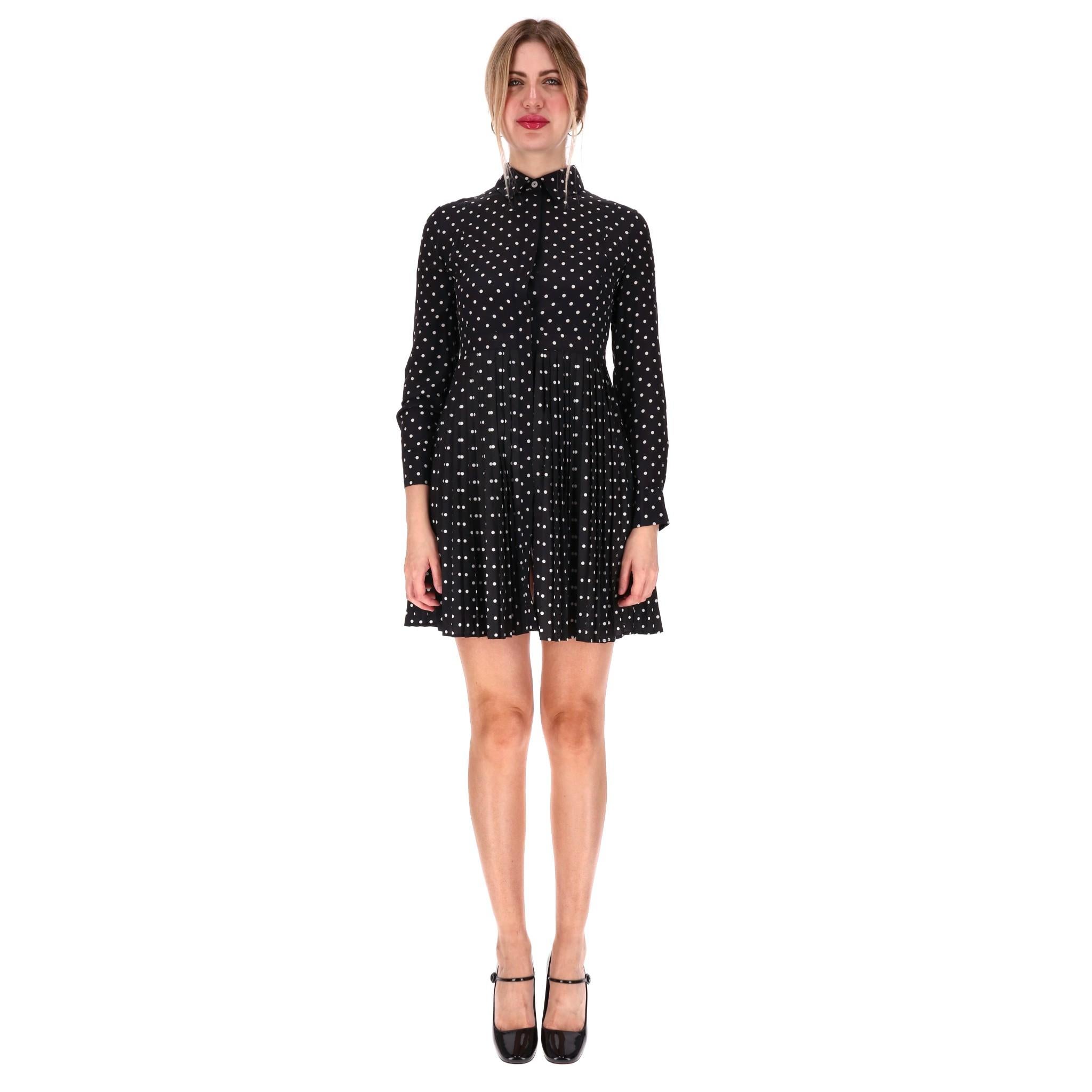 Christian Dior Silk Blend Polka-Dot Shirt Dress

Black mini dress designed with white, all-over polka-dot pattern.

Detailed with long sleeves, classic collar and centre hidden button closure.

Featuring flared pleated skirt and buttoned
