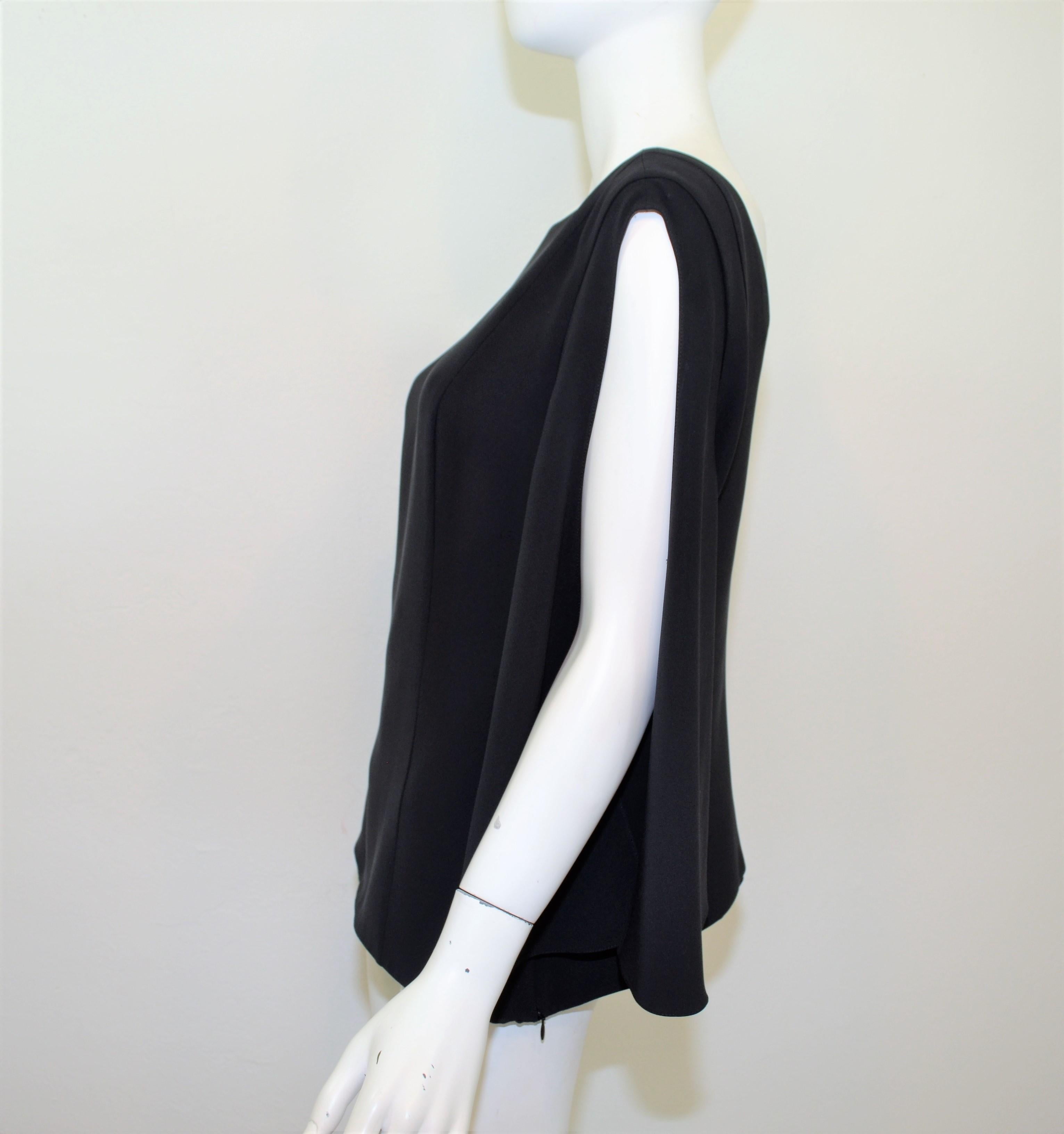Christian Dior Blouse featured in black with draped, cut sleeves, a V-Cut back, and a concealed side zipper fastening in size 12. Blouse is made in Italy, composed with 100% silk. 

Measurements:
Bust 38''
Sleeves 21'' 
Length 16''