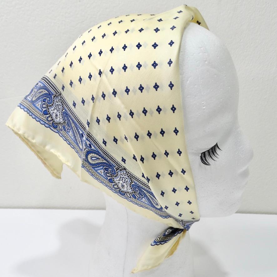 Get your hands on this stunning mid century Christian Dior silk scarf! Ivory silk features 
a blue paisley pattern adorned throughout on a luxurious silk. This silk is so soft and light weight- you have to feel it to believe it. A classic accessory