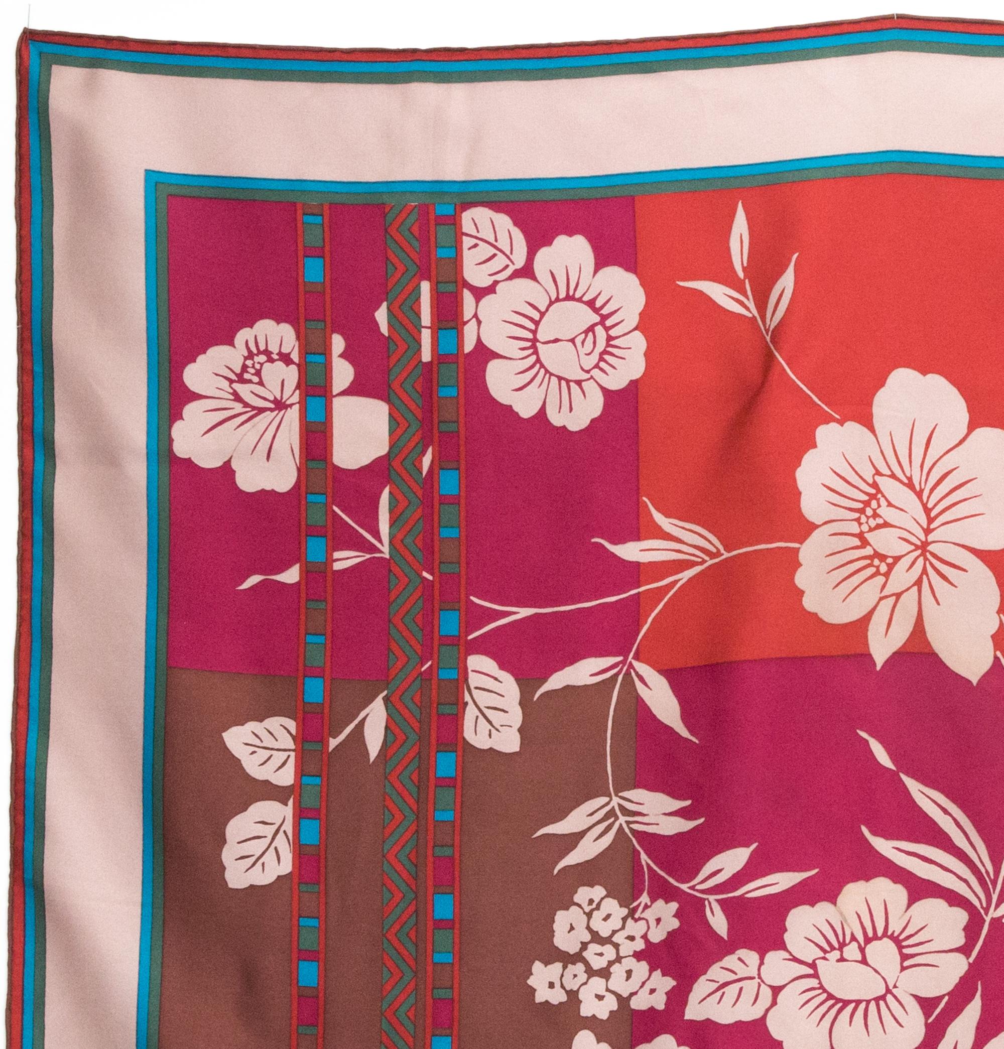 Christian Dior Red Silk Scarf featuring flowers print on a check pattern, and a top logo signature.
100% silk. 
Circa 1980s
In good vintage condition. Made in France.
30.7in (78cm)  X 30.7in (78cm)
We guarantee you will receive this  iconic item as