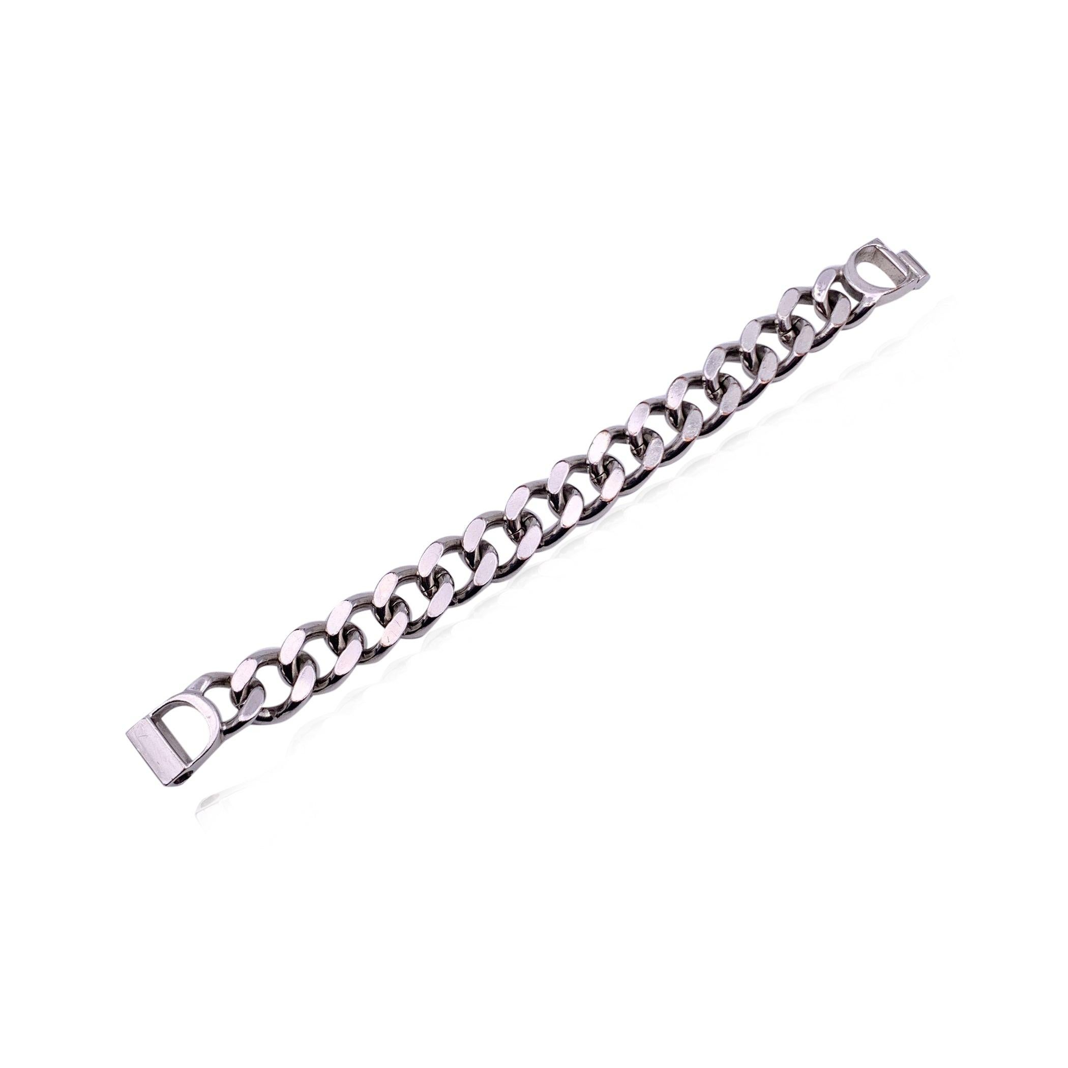 Elevate your accessory game with this Christian Dior silver Cuban chain link bracelet, a piece that seamlessly blends bold design with refined luxury. The bracelet features a classic Cuban link chain, known for its sturdy yet stylish appeal, and is