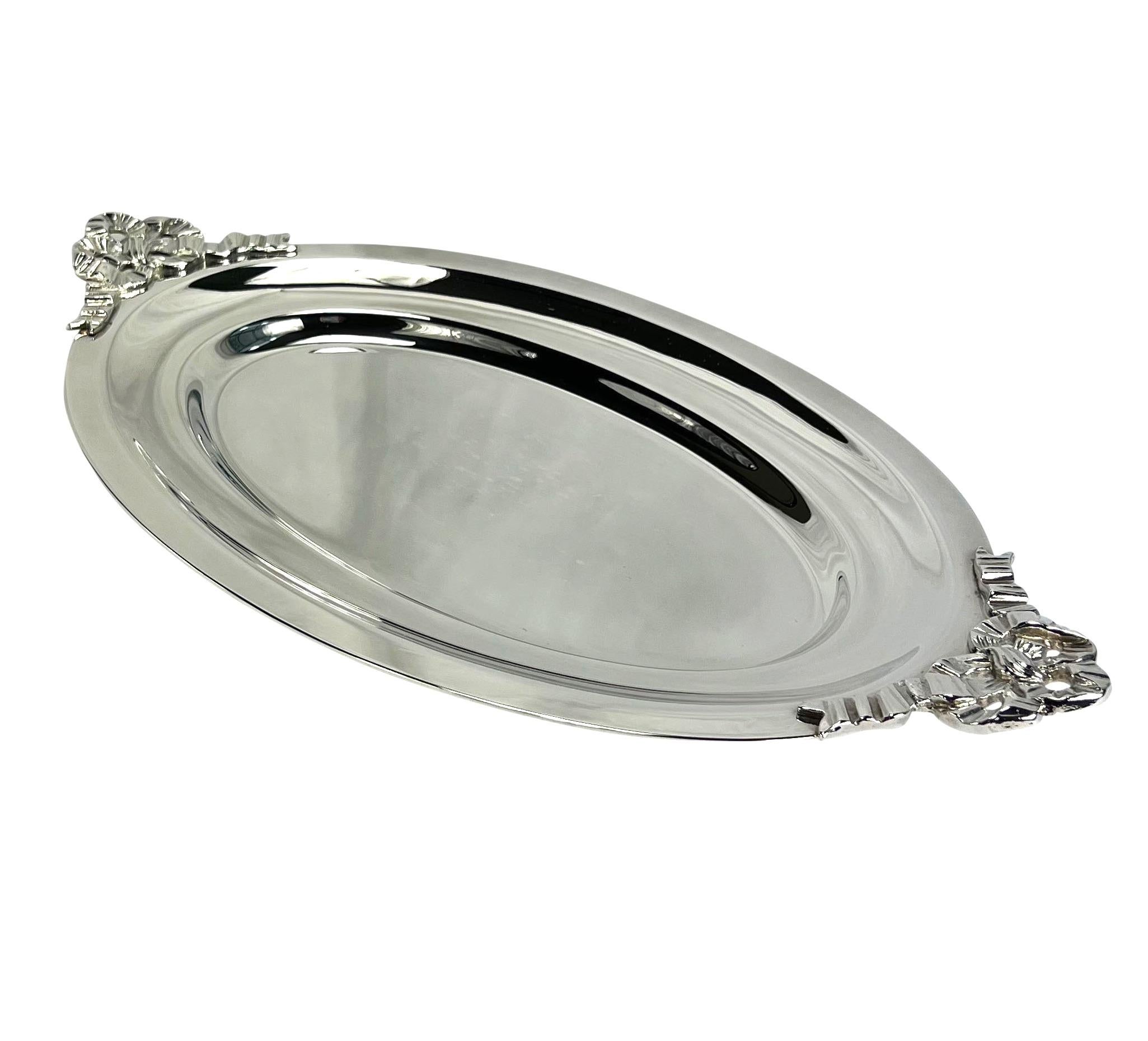 Presenting a beautiful Christian Dior oval silver plate serving plate. This vintage plate is perfect for serving or decorating and is complete with ribbon handles and its original box!

Dimensions: 
Width: 13.75