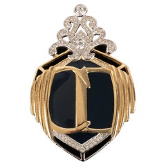 Christian Dior Broche en métal argenté et doré