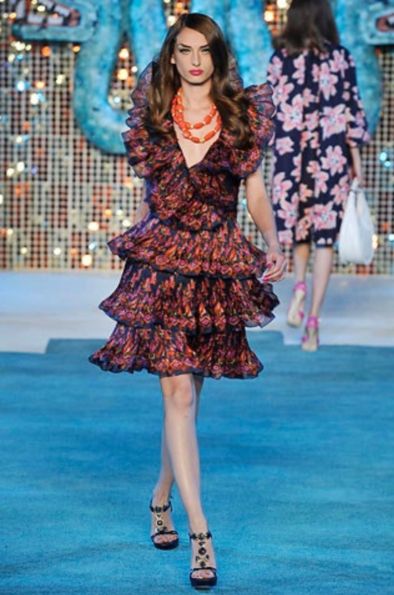 Beautiful brand new JOHN GALLIANO for CHRISTIAN DIOR Resort 2009 Runway dress (see attached photo). Indigo silk, with a unique Ikat print in blue, purple, pink, orange, and yellow. Three pleated tiers compliment the skirt. Fitted bodice, with a low