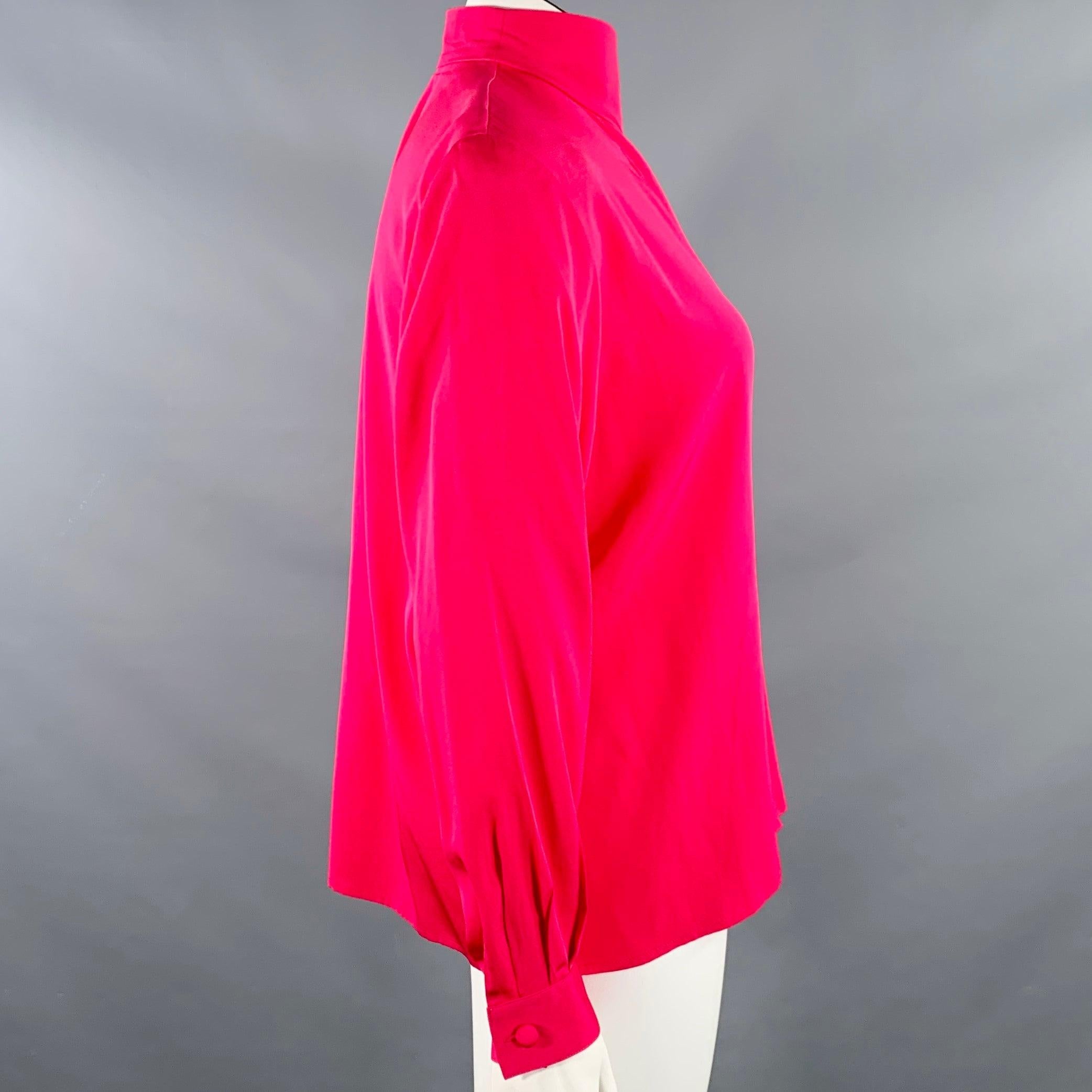 Vintage CHRISTIAN DIOR dress top
in a fuchsia pink silk featuring padded shoulders, a high neck, and hidden button closure. Made in Korea.Very Good Pre-Owned Condition. Tiny mark on front. 

Marked:   14 

Measurements: 
 
Shoulder: 17.5 inches