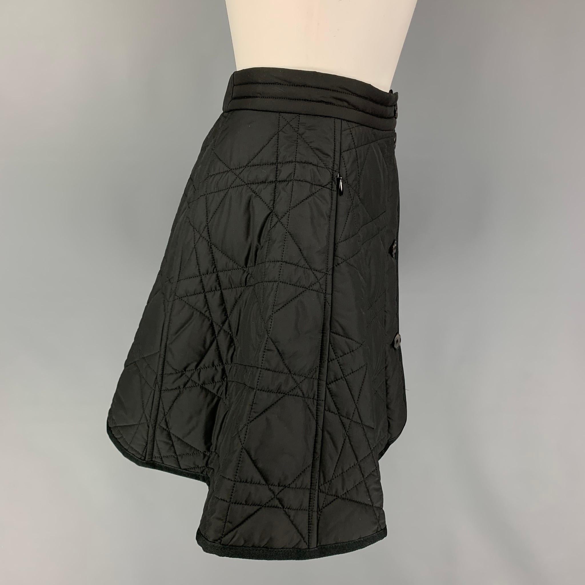 CHRISTIAN DIOR skirt comes in a black quilted polyester featuring a a-line style, zipper pockets, and a buttoned closure. Made in Italy. 

Excellent Pre-Owned Condition.
Marked: F 34 / GB 6 / I 38 / D 32 / USA 2
Original Retail Price: