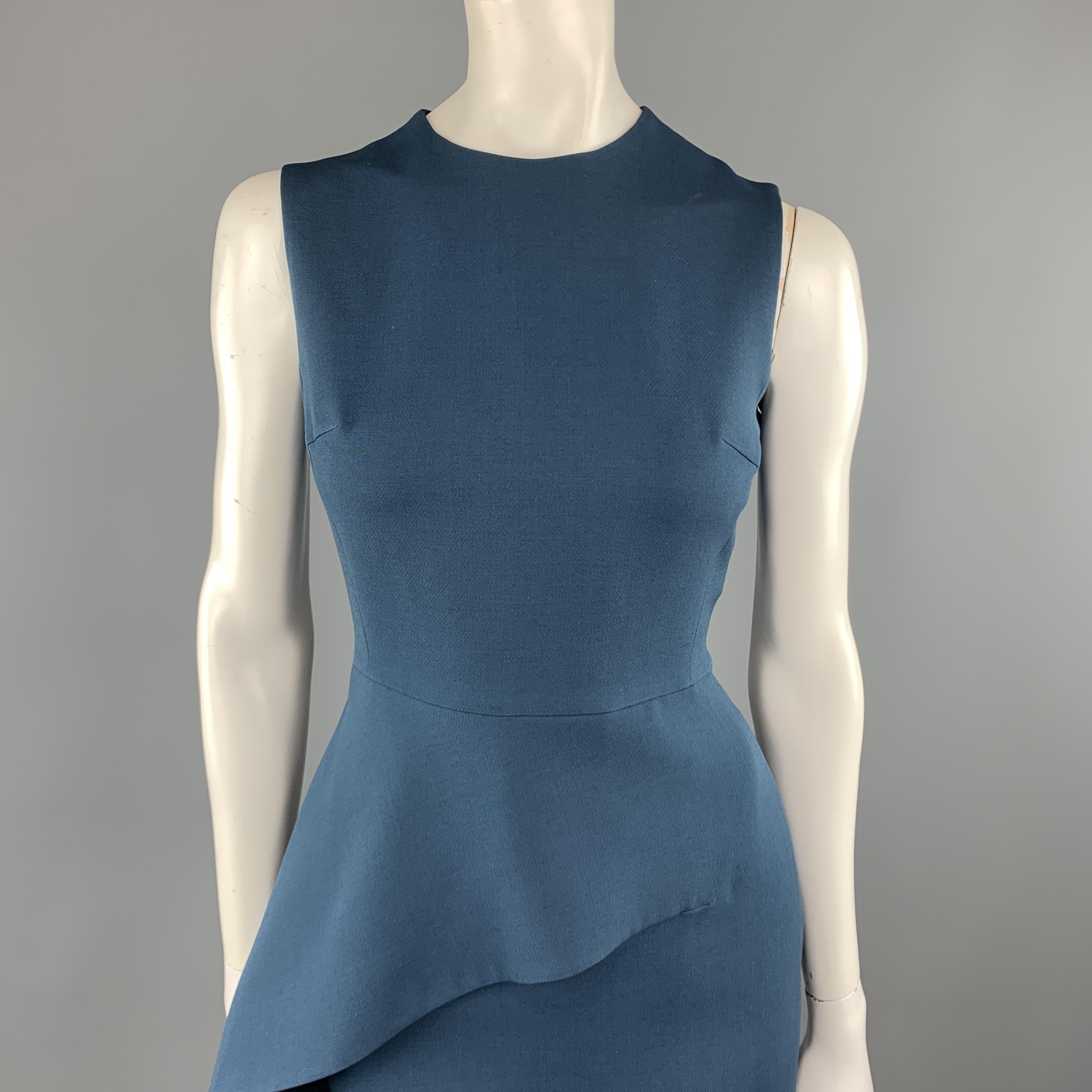 CHRISTIAN DIOR sheath dress comes in a teal blue ool silk blend fabric with a round neckline, silk liner, and asymmetrical waist peplum. Made in Italy.

Excellent Pre-Owned Condition.
Marked: 4

Measurements:

Shoulder: 13.5 in.
Bust: 35 in.
Waist: