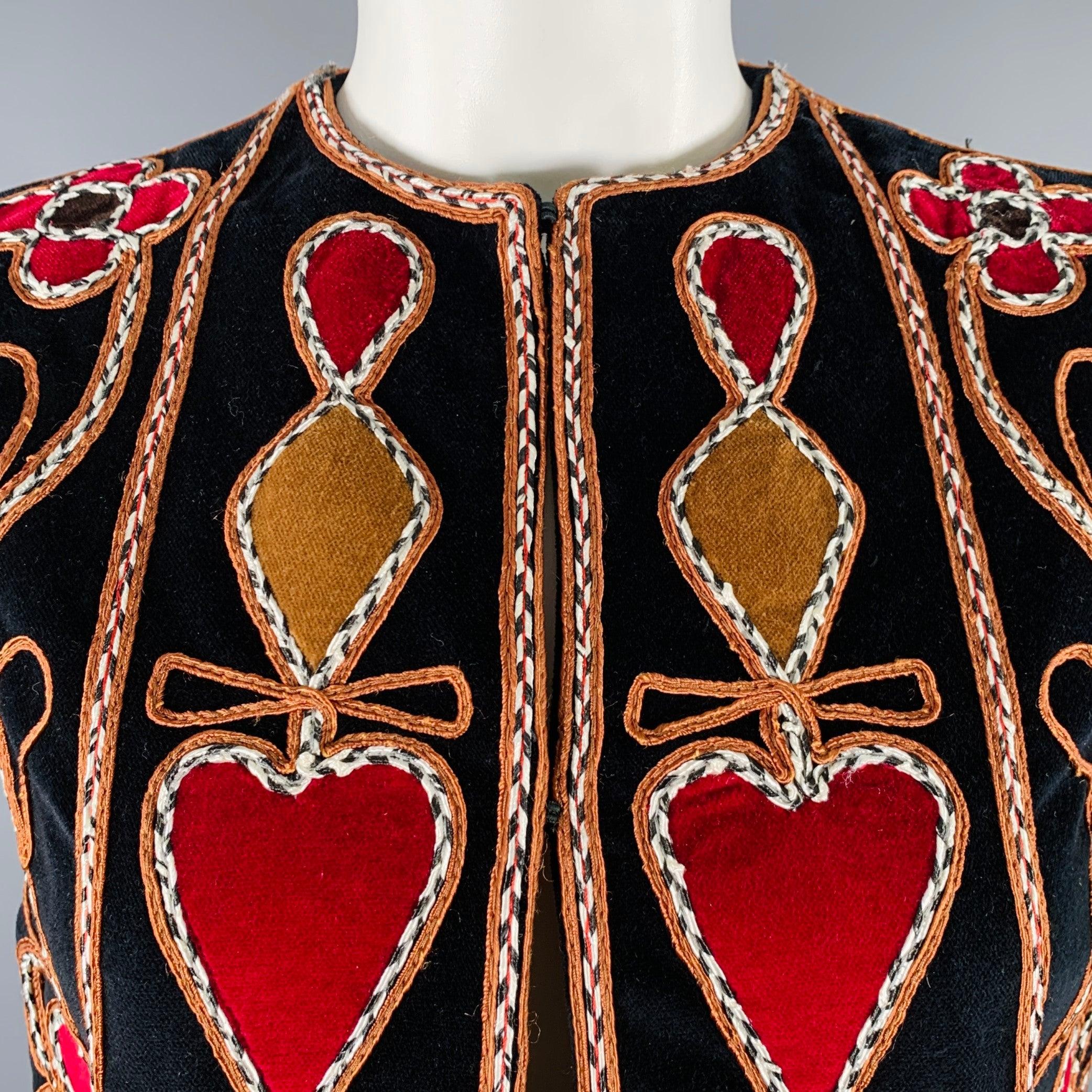 CHRISTIAN DIOR vest
in a black velvet fabric featuring a long style, embroidered floral design, and double hook & eye closure. Excellent Pre-Owned Condition. 

Marked:   F 38 

Measurements: 
 
Shoulder: 14 inches Bust: 36 inches Length: 32.5 inches