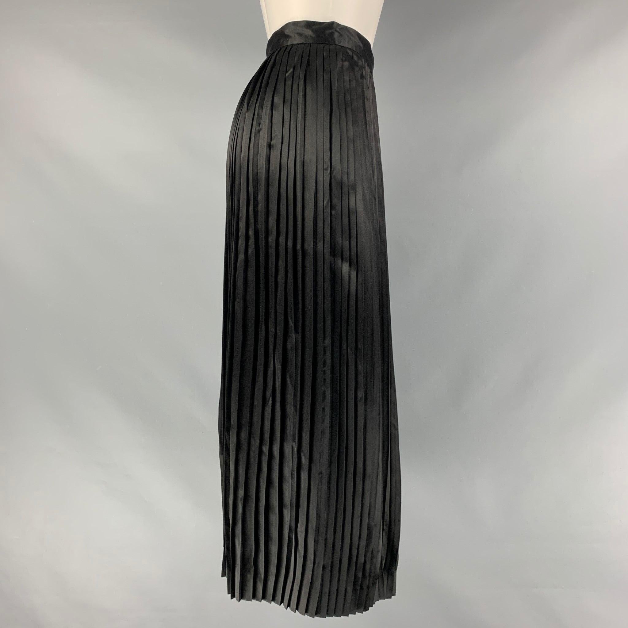 CHRISTIAN DIOR Mid-Calf skirt comes in a black silk material featuring a pleated style and an seam side zip up closure. Made in France.Excellent Pre-Owned Condition. 

Marked:   4 

Measurements: 
  Waist: 26 inches Hip: 50 inches Length: 33 inches 