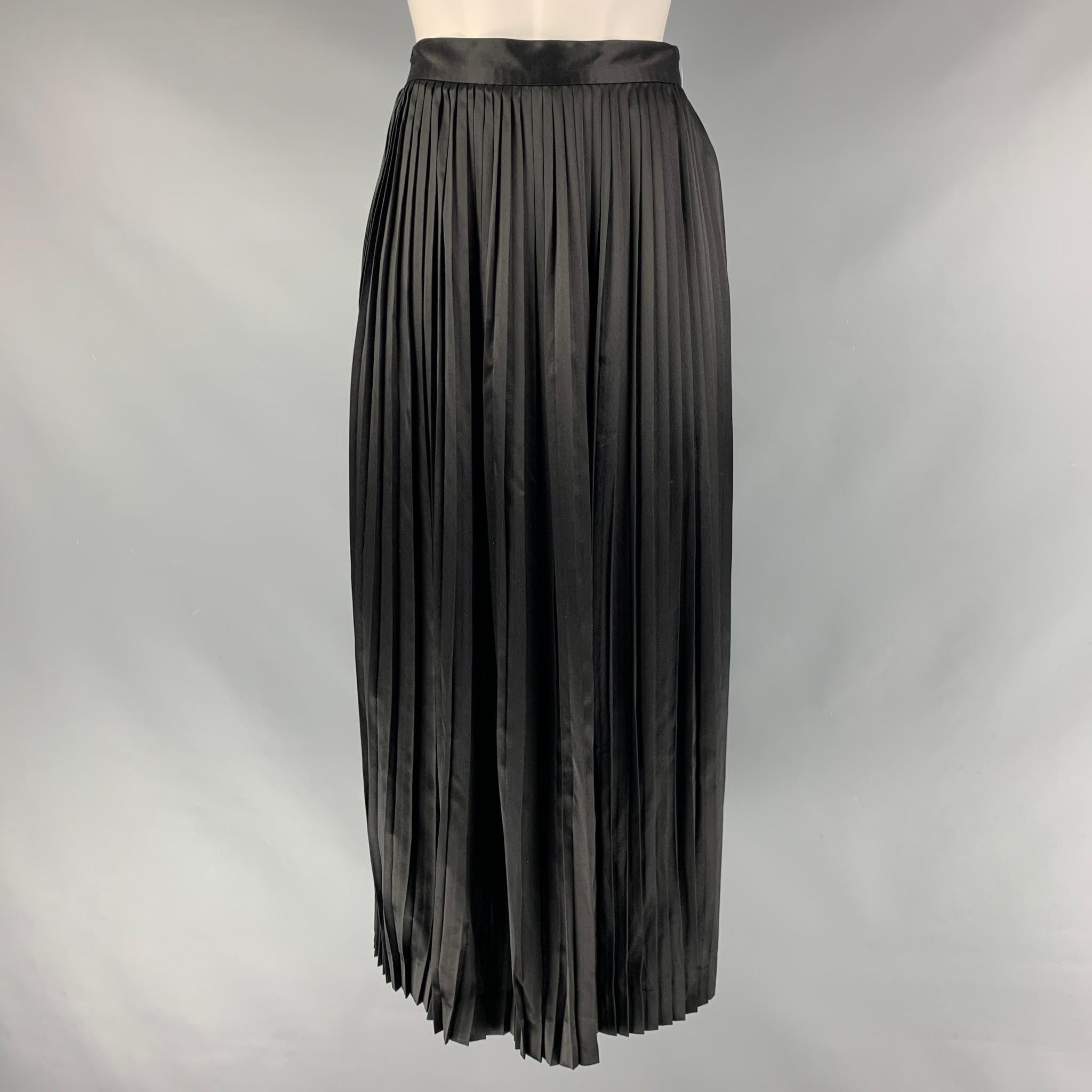 CHRISTIAN DIOR Mid-Calf skirt comes in a black silk material featuring a pleated style and an seam side zip up closure. Made in France.

Excellent Pre-Owned Condition.
Marked: 4

Measurements:

Waist: 26 in.
Hip: 50 in.
Length: 33 in.  