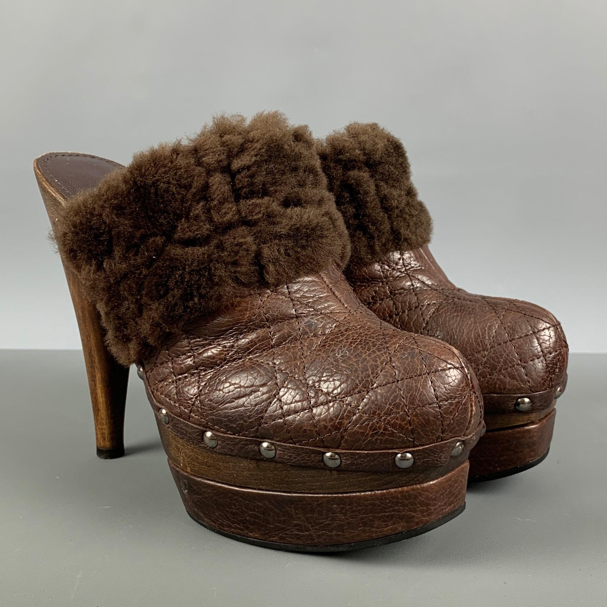 CHRISTIAN DIOR pumps comes in a brown leather featuring a quilted style, brown shearling lining, silver studded detail and platform style. Made in Italy.Very Good Pre-Owned Condition. 

Marked:   38 

Measurements: 
  Heel: 6 inches Platform: 1.5