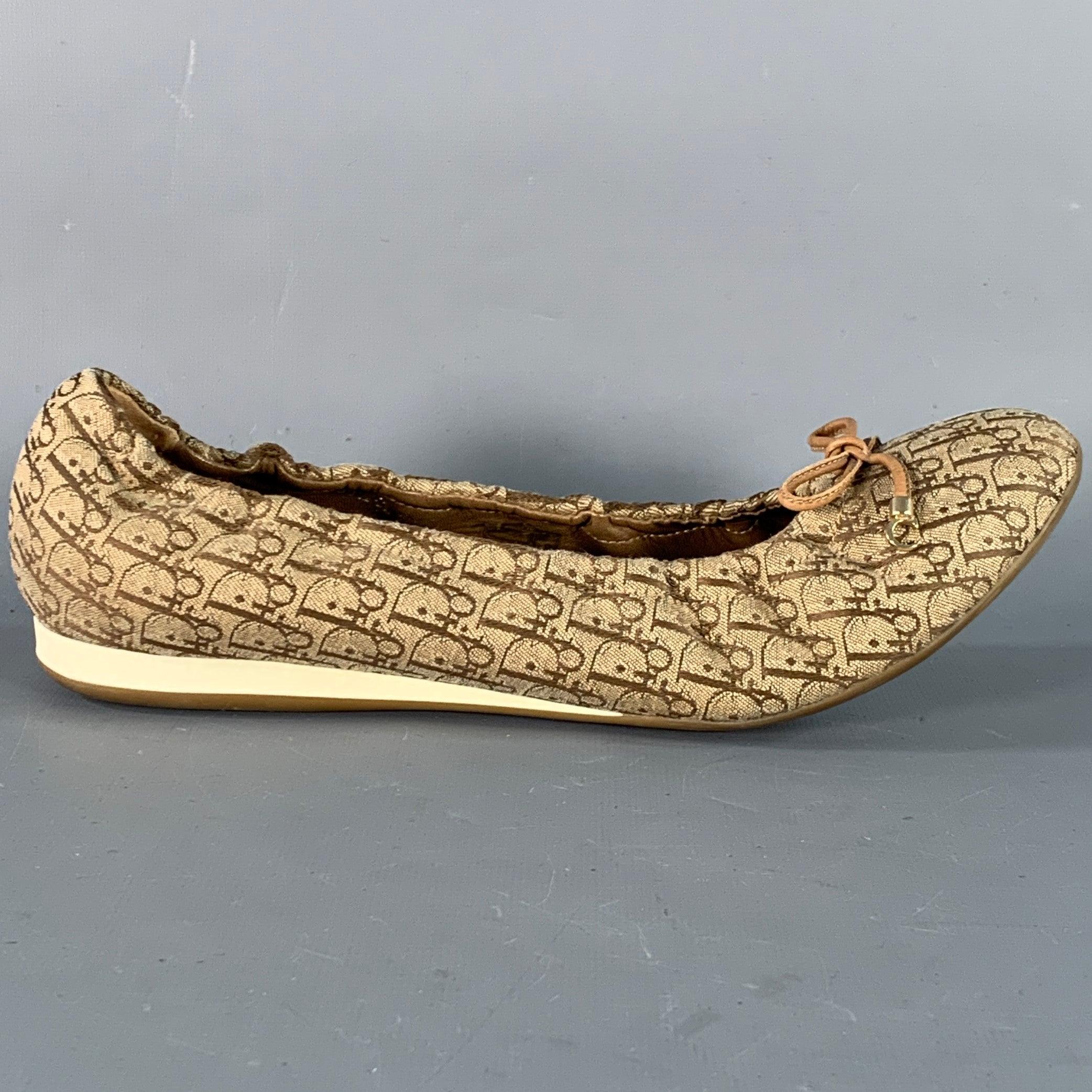 CHRISTIAN DIOR flats
in a tan and brown canvas featuring signature Oblique monogram pattern, bowtie details with CD aglet accents, and slip on closure. Made in Italy.Very Good Pre-Owned Condition. 

Marked:   36.5 CL 1007
Outsole: 10.25 inches  x