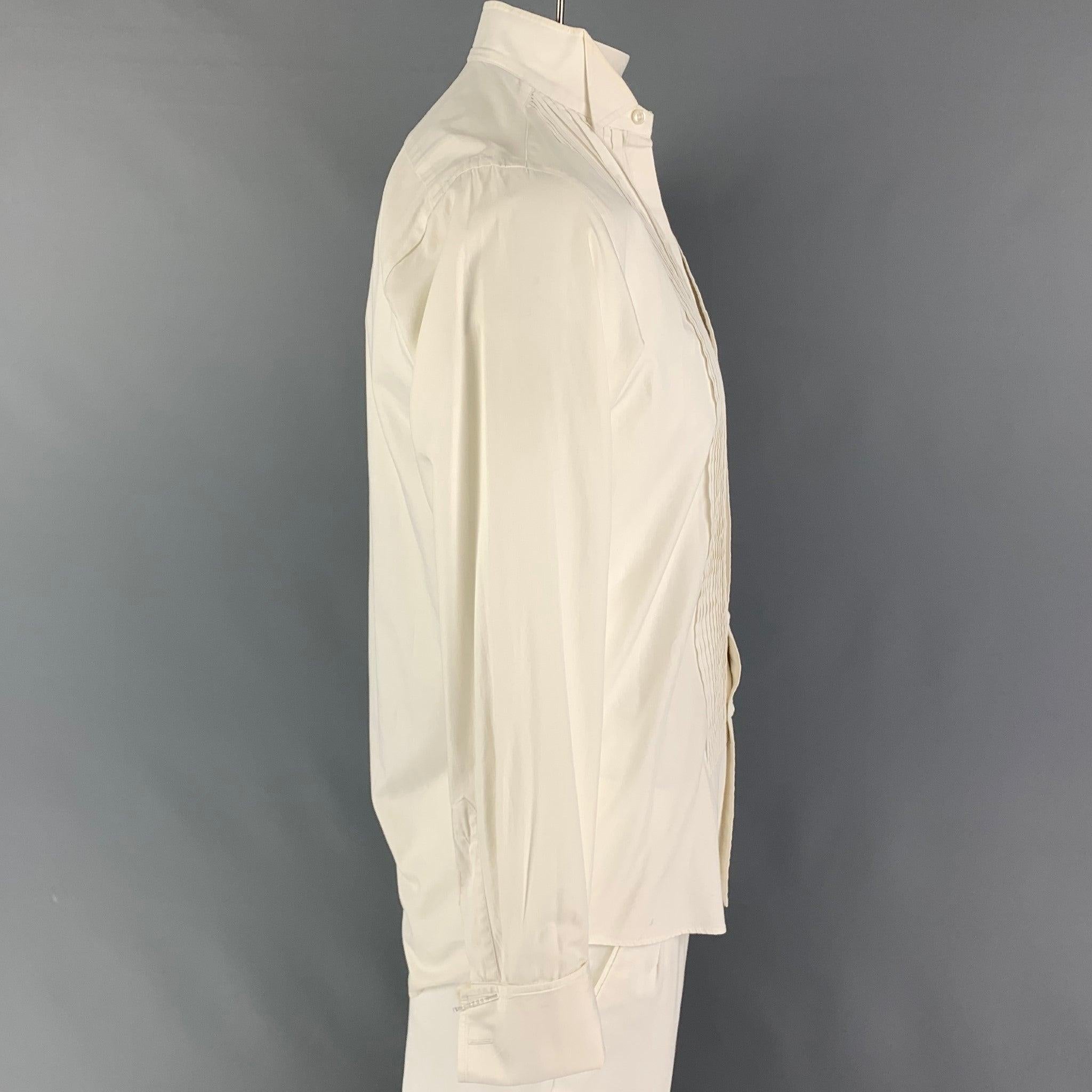 CHRISTIAN DIOR long sleeve shirt comes in a off white pleated cotton featuring a laydown collar, french cuffs, and a buttoned closure. Cufflinks are not included. Made in USA.
 Good
 Pre-Owned Condition. Missing buttons. Minor wear.  
 

 Marked: 