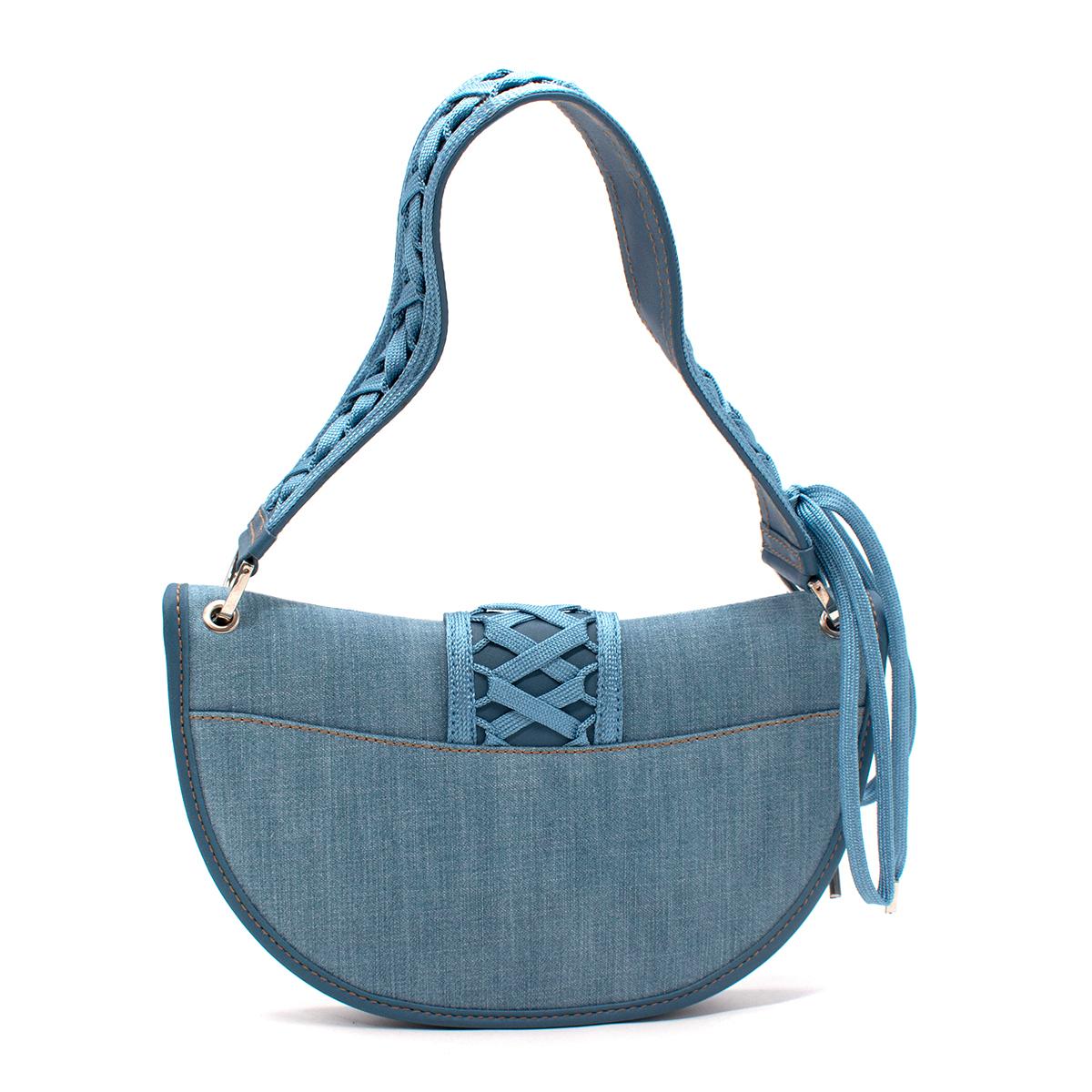Christian Dior Small Admit It Denim Lace-Up Detail Shoulder Bag 

- 90's style shoulder bag in light denim blue canvas with lace-up detail
- Silver-tone hardware and logo plate
- Matching leather trims with jeans-style stitching
- Wide leather
