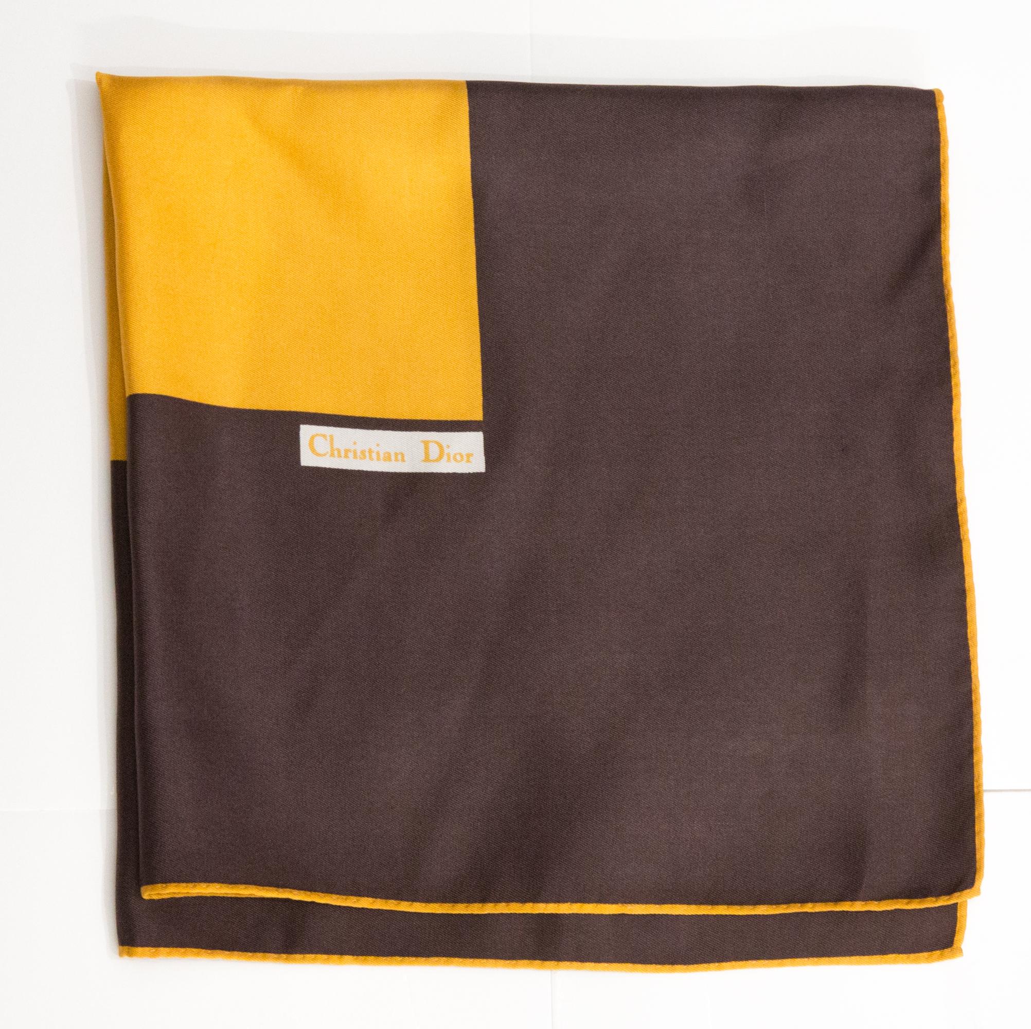 Christian Dior Small Silk Scarf featuring a large brown border,  a Christian Dior signature. 
Circa 1980s
In good vintage condition. Made in France.
19.3in (48cm)  X 19.3in (48cm)  
We guarantee you will receive this  iconic item as described and