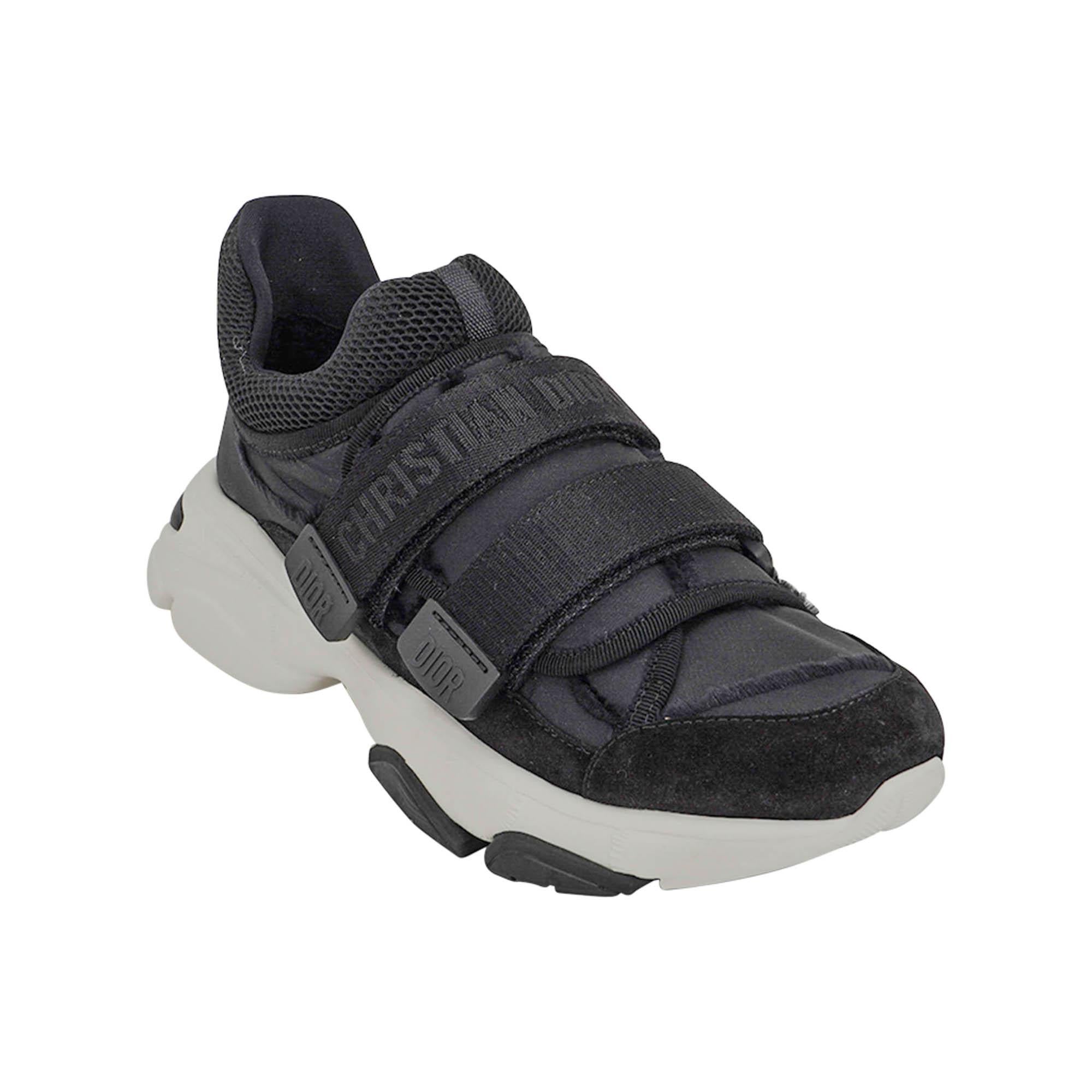 Mightychic offers a pair of Christian Dior D-Wander Sneakers featured in Black.
The Camouflage Nylon sneaker has 2 velcro straps over top of shoe, one is logo embossed.
Straps have logo tabs.
White rubber soles with Christian Dior embossed on
