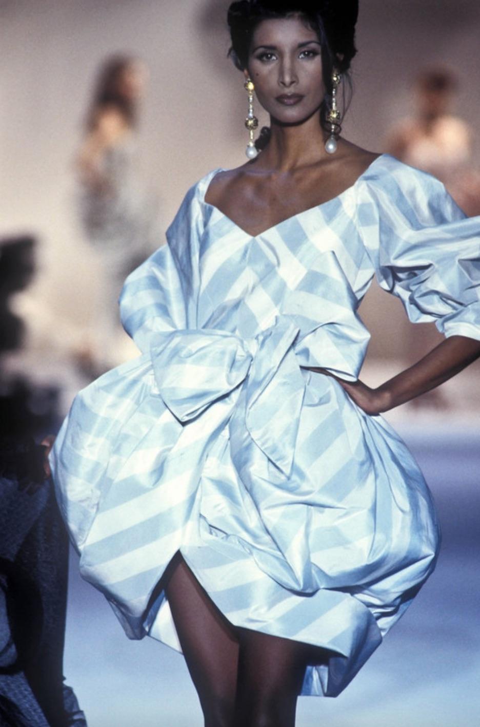 This stunning vintage piece from Spring Summer 1993 by Gianfranco Ferre for Christian Dior is a sight to behold - made of luxurious sky blue and white striped silk taffeta, this dress brings a regal edge. The gorgeous off-the-shoulder style with