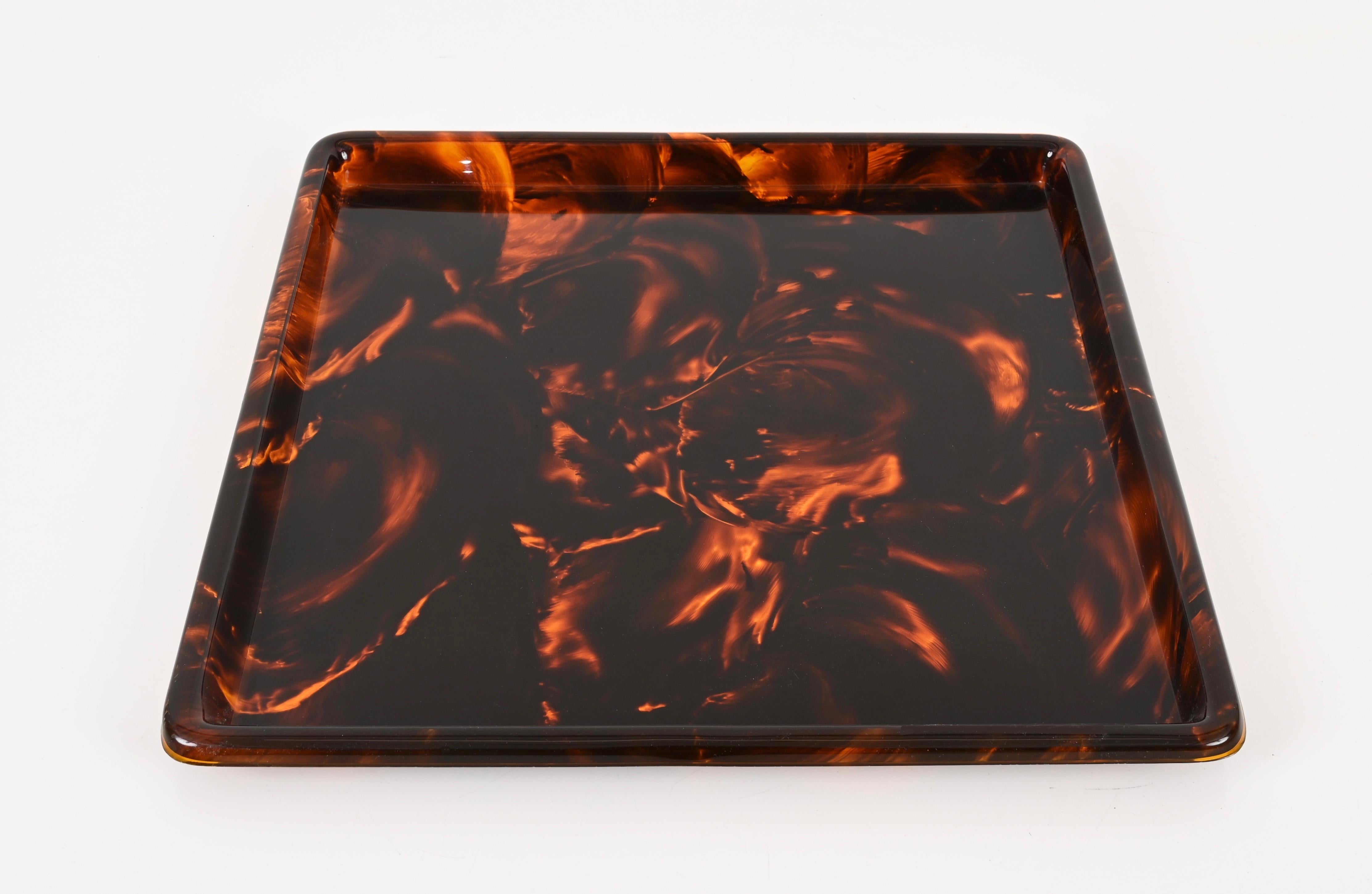 Gorgeous large Mid-Century square serving tray in tortoiseshell lucite. This stunning tray was produced in Italy in the 1970s.  Its design is in the style of Willy Rizzo for a Christian Dior home production.

The quality of the lucite in this square