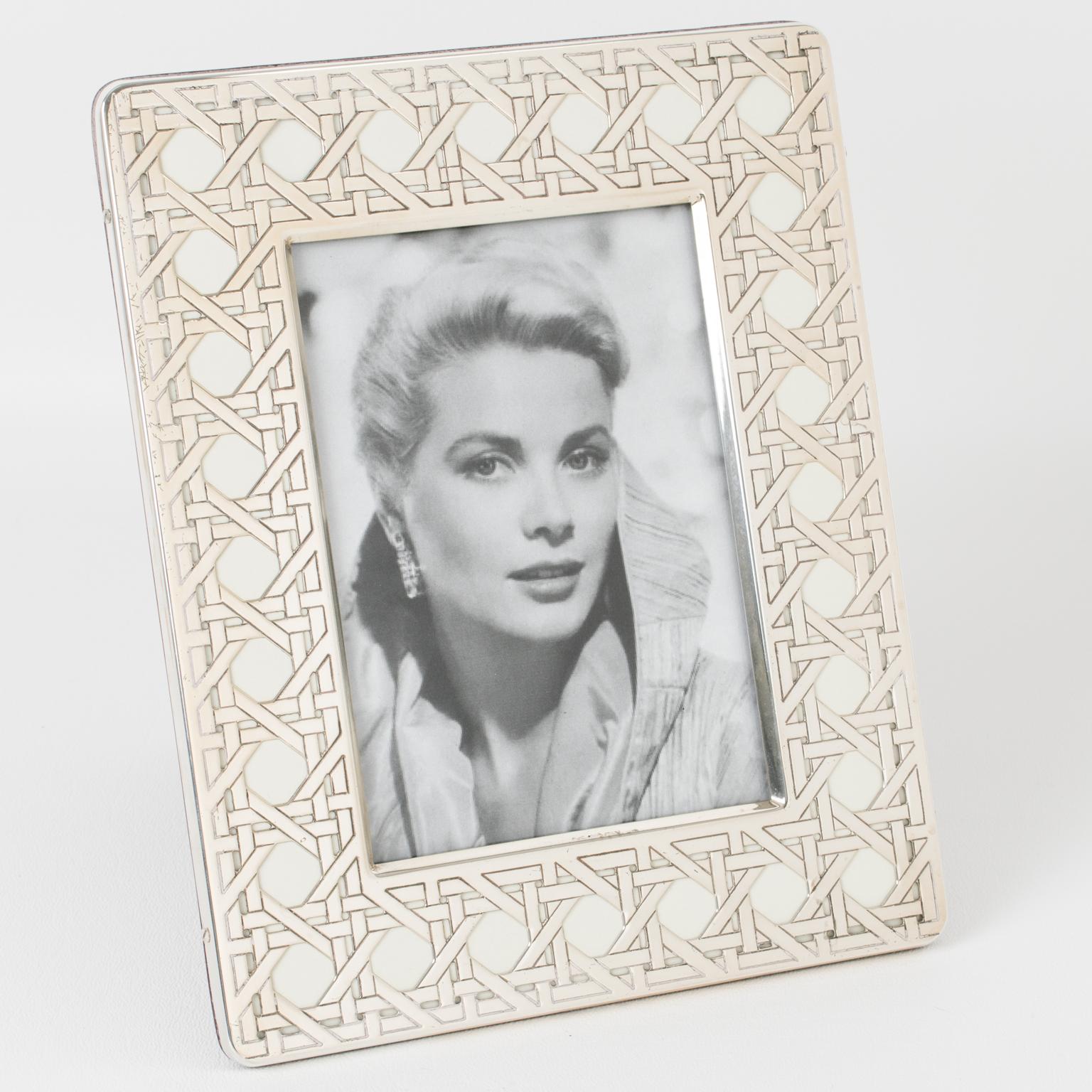 A lovely Christian Dior Paris sterling silver picture photo frame. The piece features a rectangular shape with carved wicker cane-work textured patterns. The back and easel are in high gloss varnish dark wood. The frame is marked on the edge with