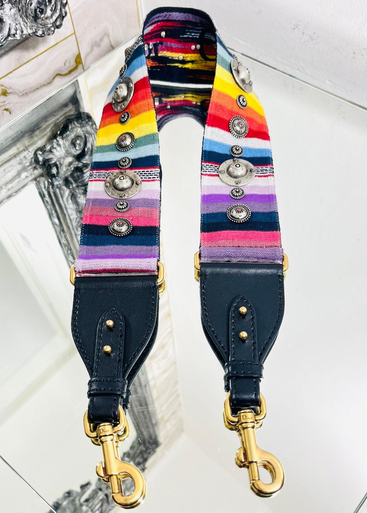 Christian Dior Studded Rainbow Bag Strap

Multicoloured shoulder strap studded with silver medallions and designed with 'Christian Dior' embroidery on the reverse.

Featuring black leather ends with aged gold 'Dior' engraved clasps.

Size – One