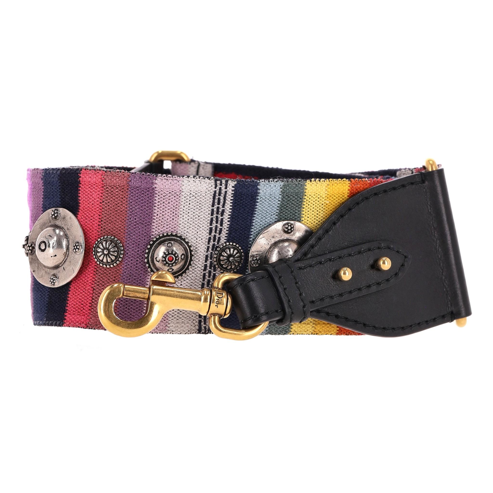 Christian Dior Studded Rainbow Bag Strap

Multicoloured shoulder strap studded with silver medallions and designed with 'Christian Dior' embroidery on the reverse.

Featuring black leather ends with aged gold 'Dior' engraved clasps.

Rrp Approx.