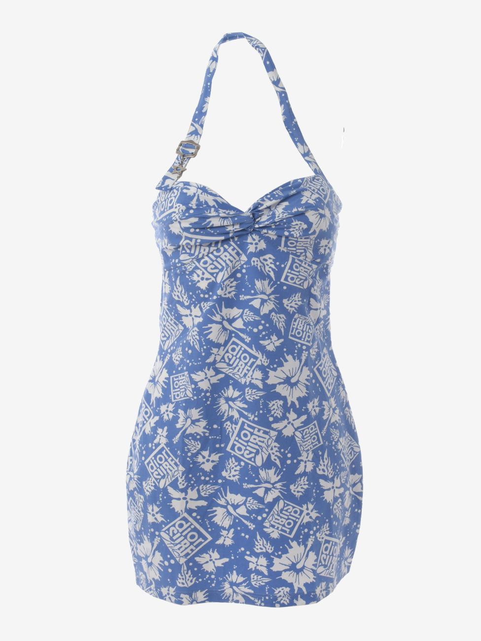 Christian Dior Beach Suit is a rare two-piece suit from John Galliano J'adore 1947's Surf Chick collection made in 2004, consisting of a bikini and beach dress featuring a monogram hibiscus print and adjustable closures with logoed metal charms.