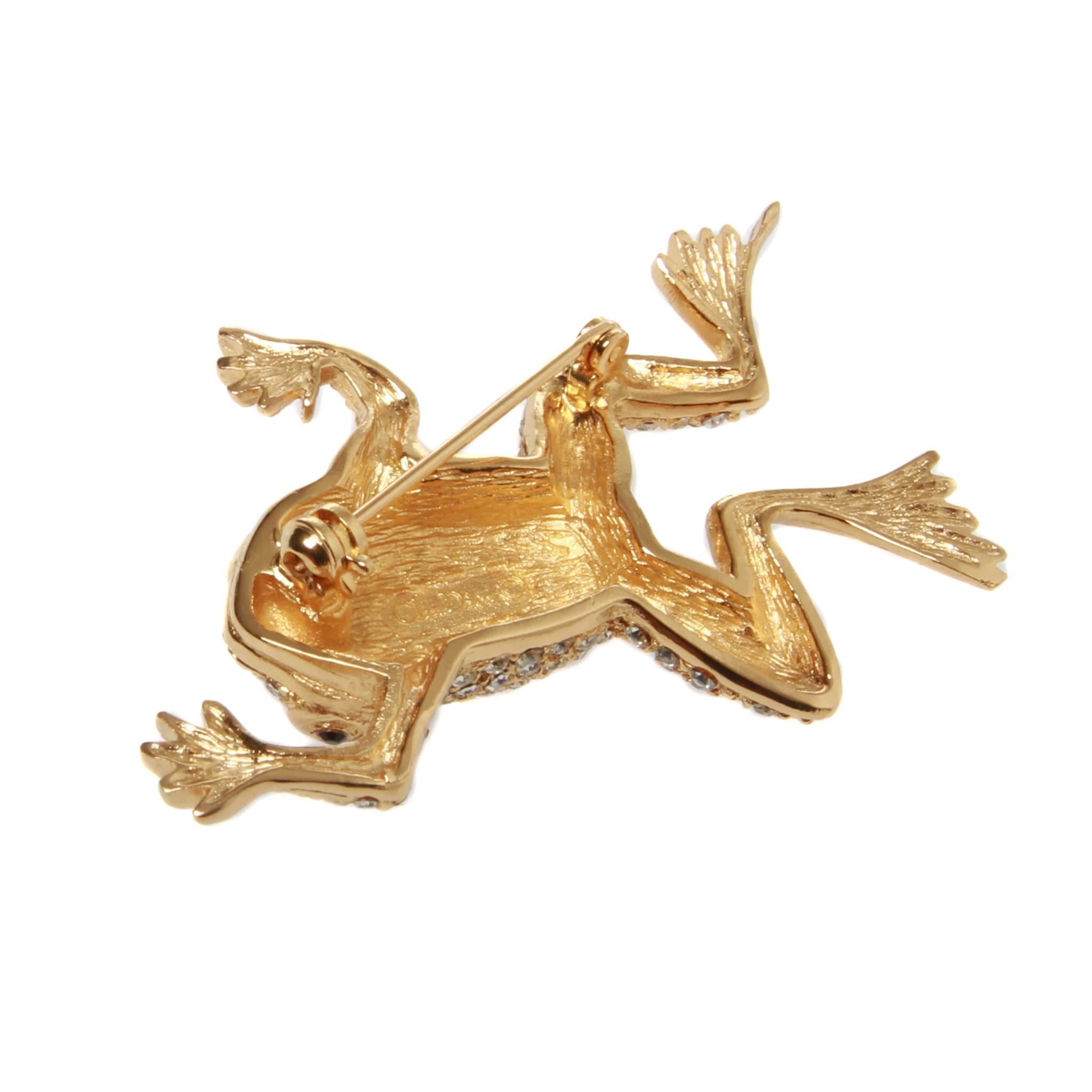 	
Vintage signed Christian Dior gold tone and clear rhinestone crystal frog brooch. 
Made by Henkel & Grosse on license for Christian Dior in the 1980's this lovely brooch depicts a swimming frog.
With polished gold tone webbed feet, the remainder
