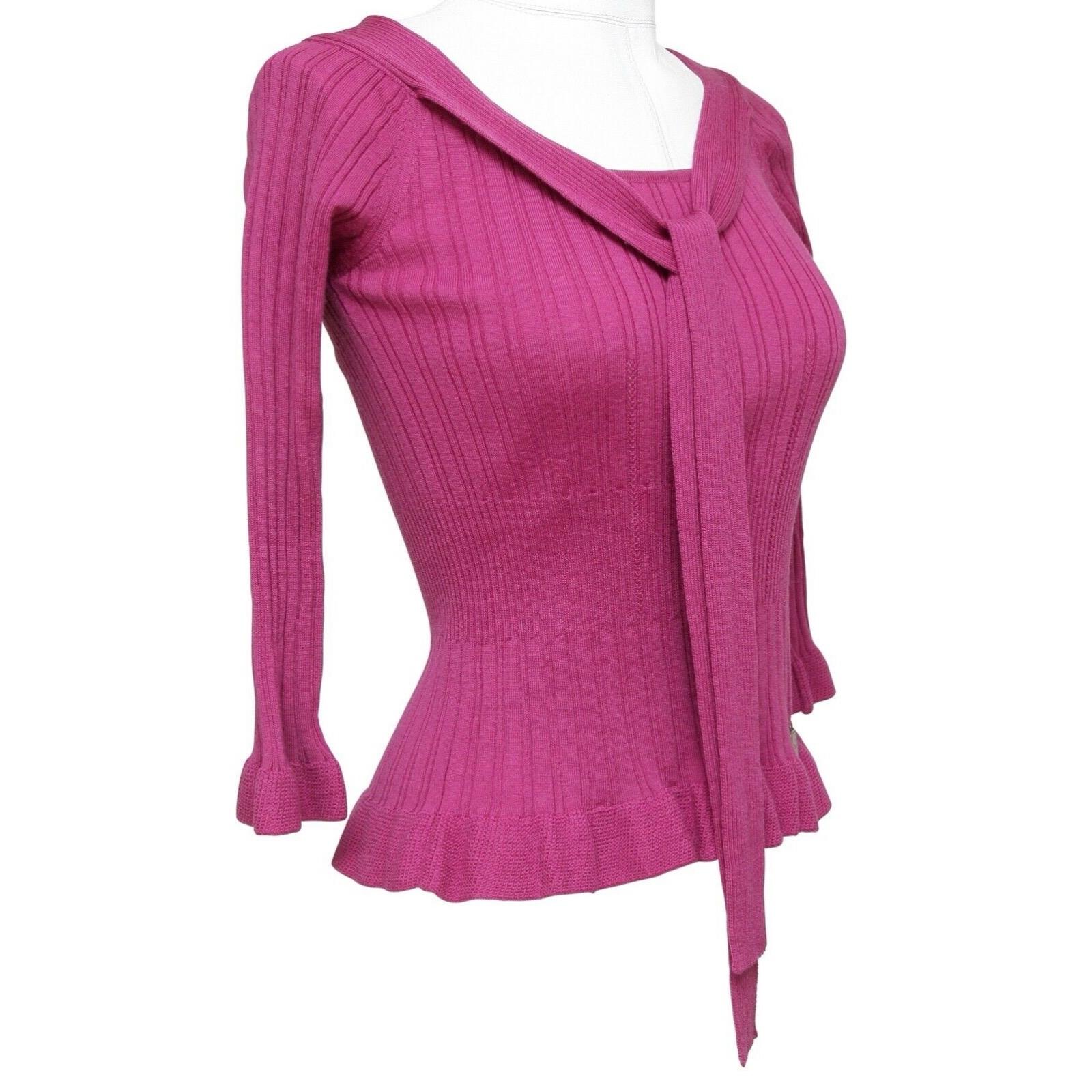 GUARANTEED AUTHENTIC LOVELY CHRISTIAN DIOR MAGENTA KNIT SWEATER WITH NECK TIE

Details:
- Lightweight magenta ribbed wool pull-over sweater.
- Scoop neck with tie.
- 3/4 sleeve.
- Designer plaque at left hip.
- Flair at hem and cuffs.

Size: F 36,