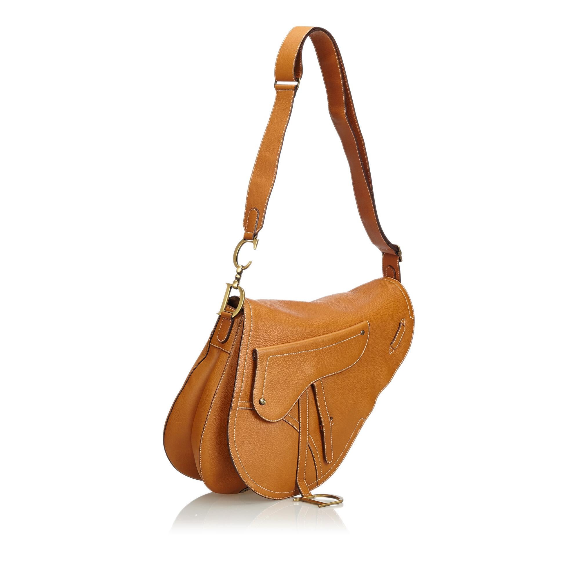 Christian Dior Tan Calfskin Baudrier Saddle Bag

- saddle shaped pocket 
- dangling 