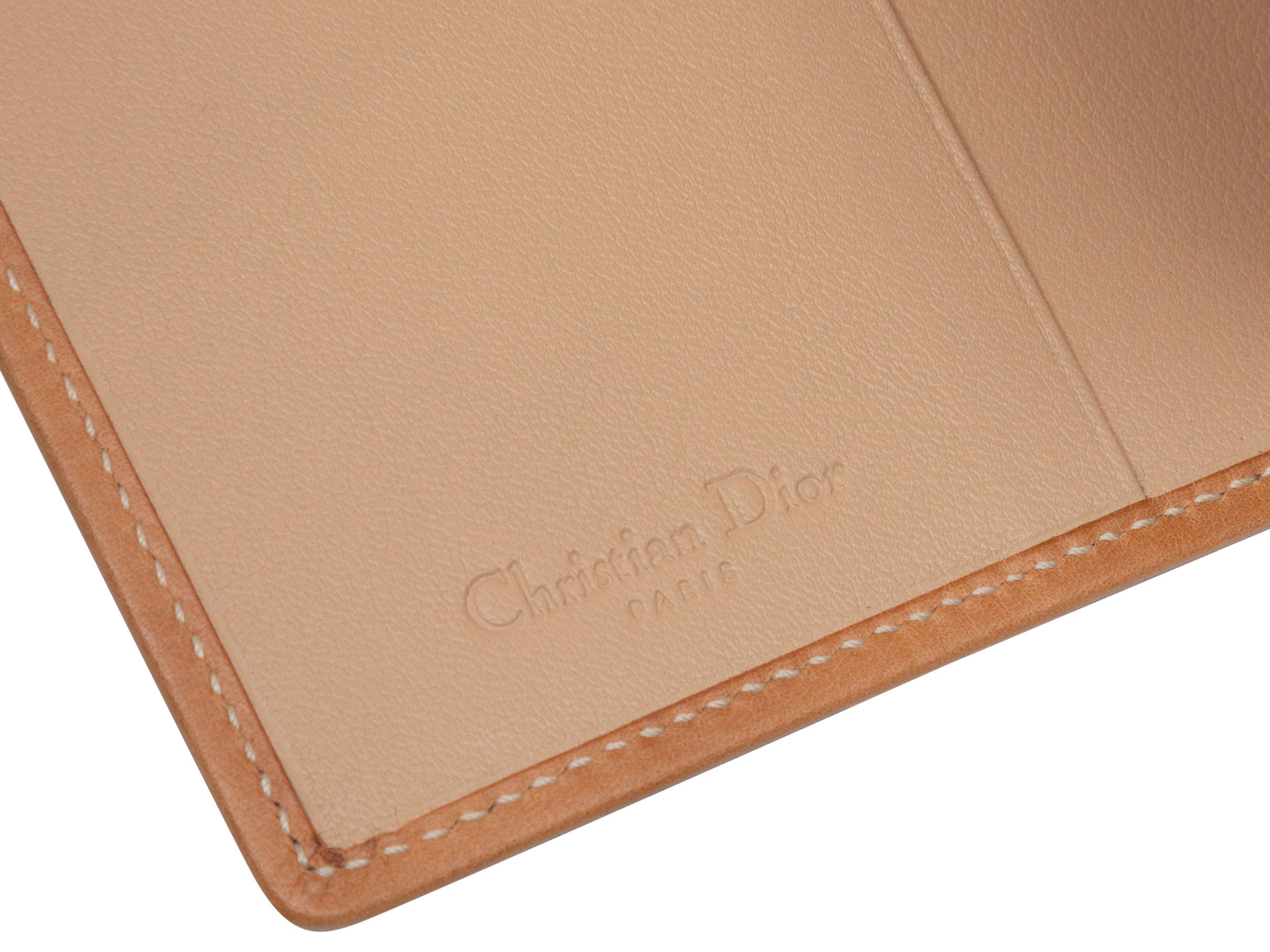 Product Details: Tan Oblique patterned canvas and leather-trimmed passport holder by Christian Dior. 5.5