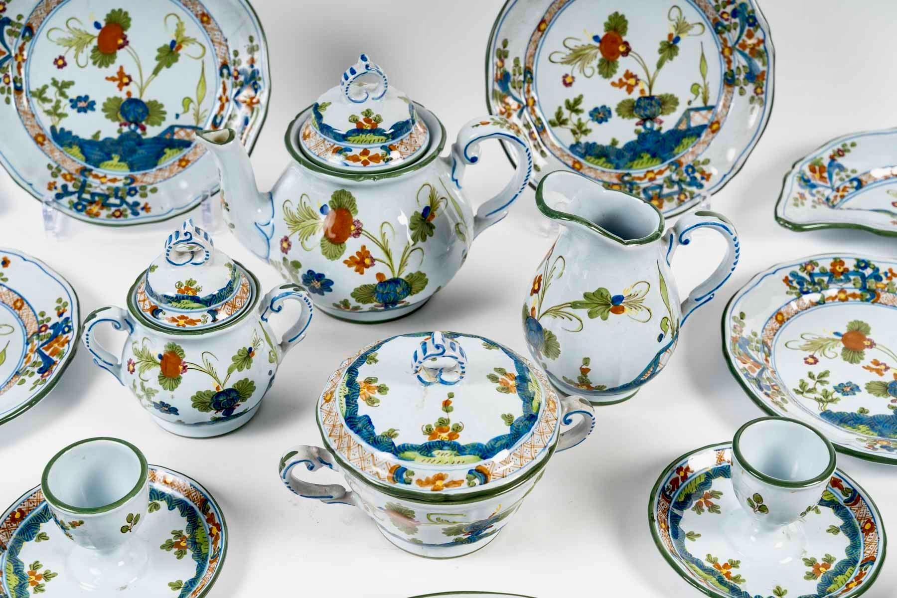 Tete-a-Tete Breakfast set for 2 people made in hand-painted  Faenza Italian faience with design of Indian Garofano (kind of carnations from India)  by Christian Dior in 1975s.
Each piece is signed 