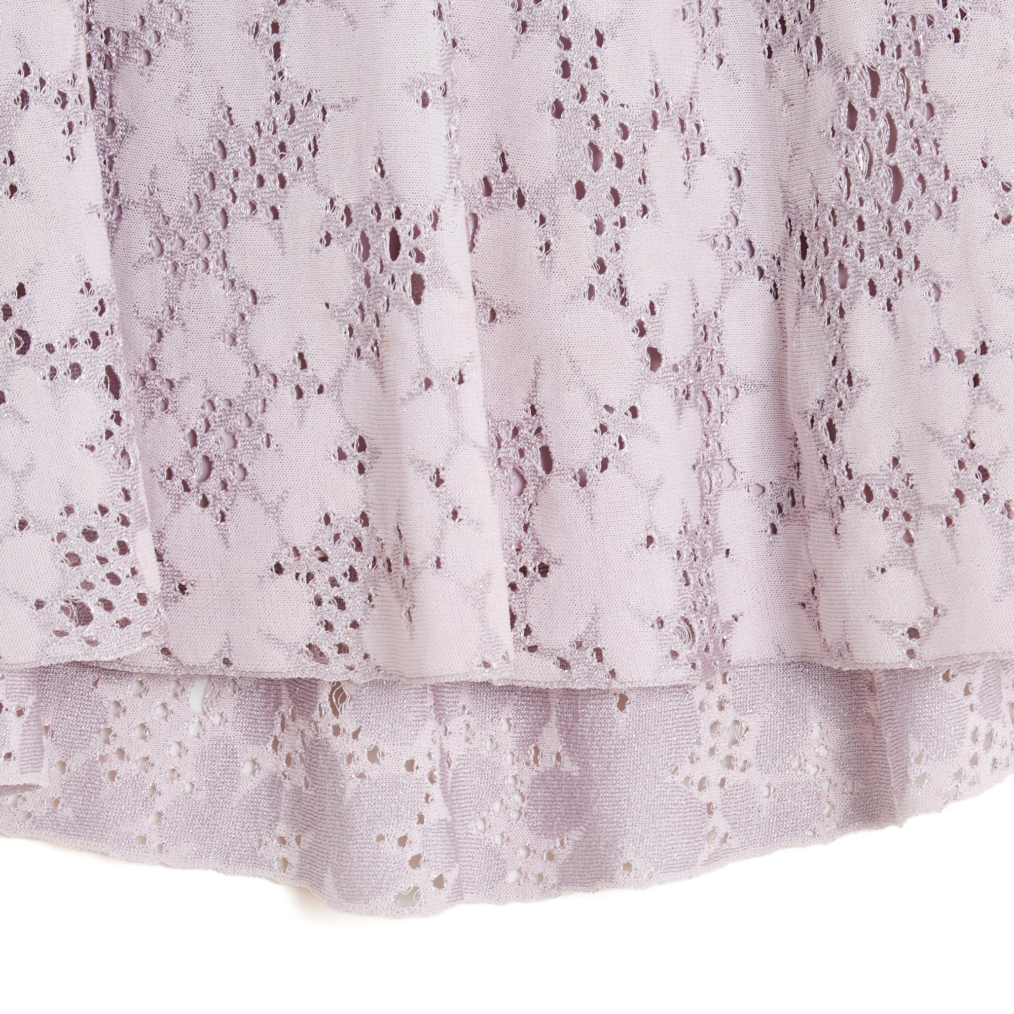 Christian Dior top in silk jersey knitted in a floral pattern and an open mesh and embellished with silver lurex thread, round neck closed by 2 small buttons hidden in the back, flared volume, front side shorter than the back, small short sleeves,