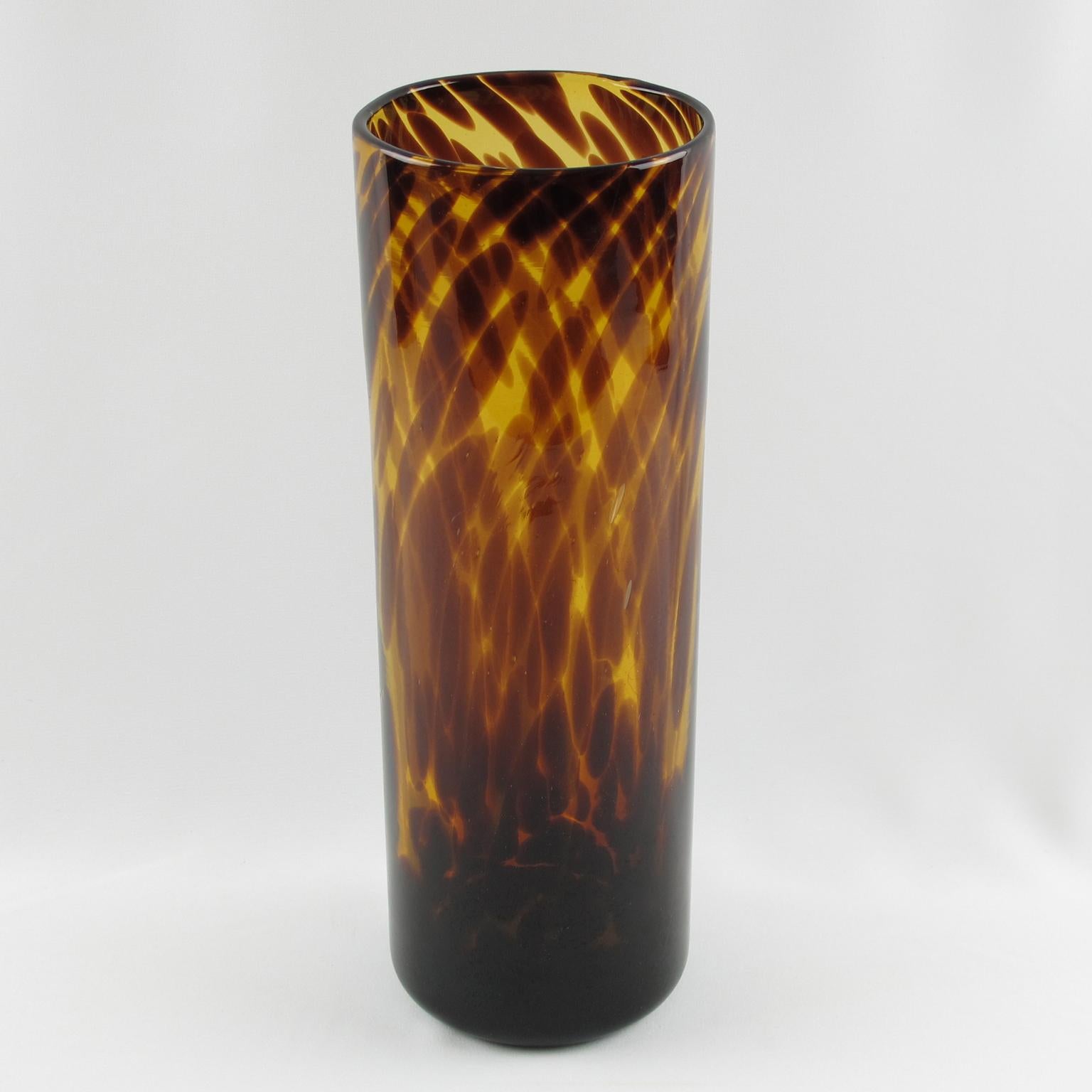 Extra tall modernist tumbler glass vase manufactured by Empoli, Italy for the Christian Dior Home Collection. Mouth-blown glass with exclusive tortoiseshell (tortoise) flowing colored pattern.
Measurements: 4.93 in. diameter (12.5 cm) x 13.75 in.