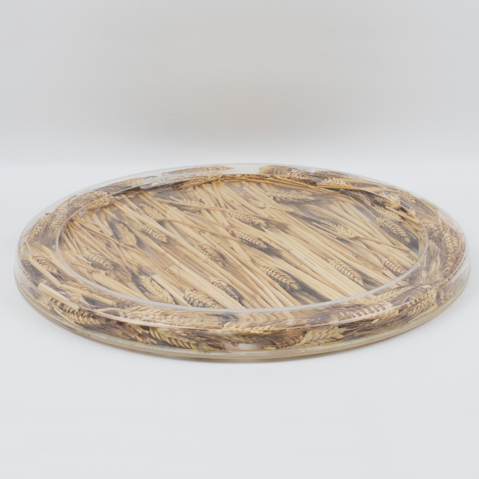 This is a very special and unique serving tray, designed by Christian Dior in the 1970s for his Home Collection. This board or platter has a rounded shape and raised edges. With a natural organic touch, it is made of clear Lucite or plexiglass with