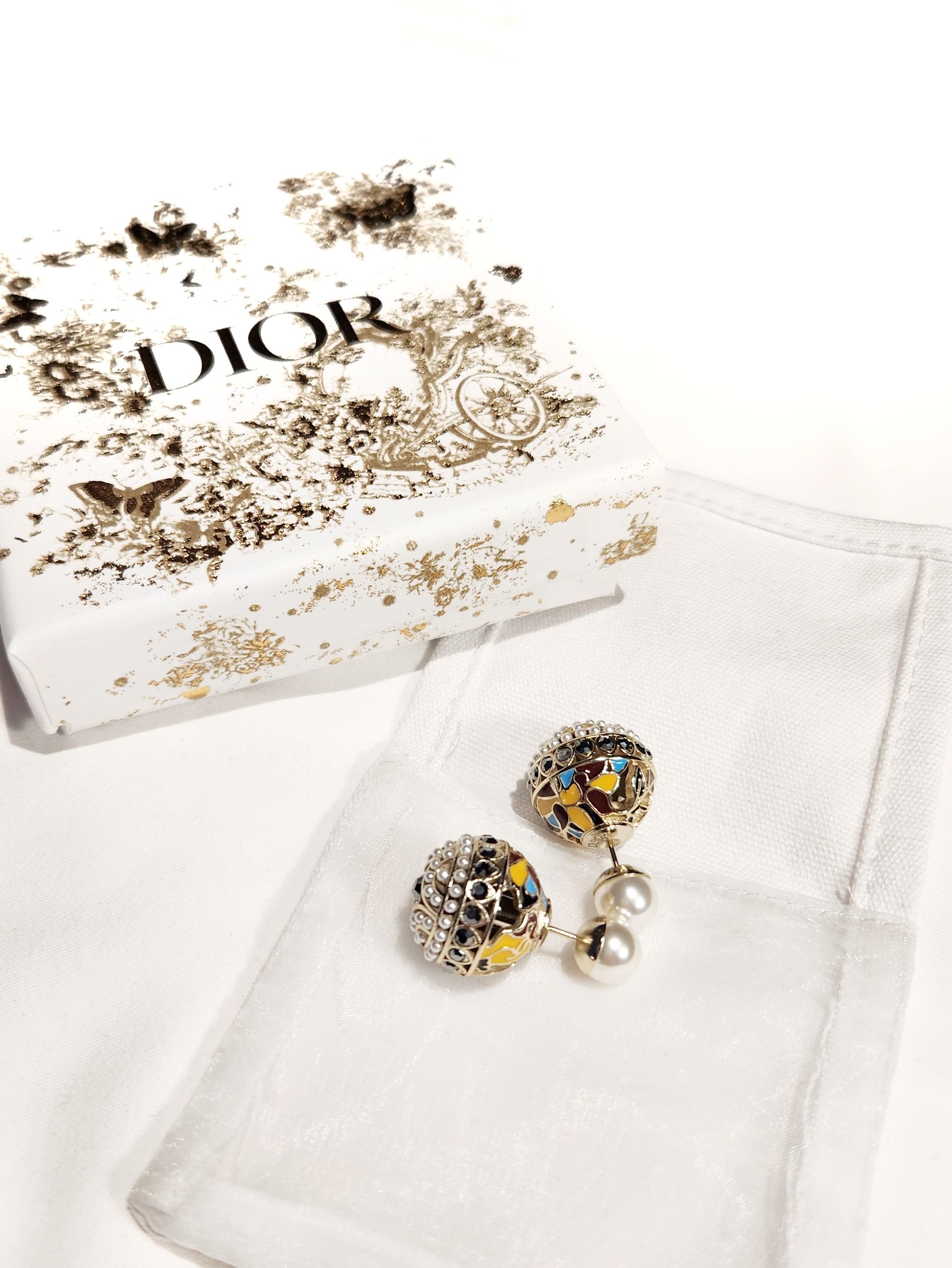 Indulge in the epitome of opulence with the Christian Dior Tribales Coloured Enamel Metal Black Rhinestones Pearls Earrings. These exquisite earrings are a harmonious blend of vibrant colors, intricate detailing, and luxurious materials, reflecting