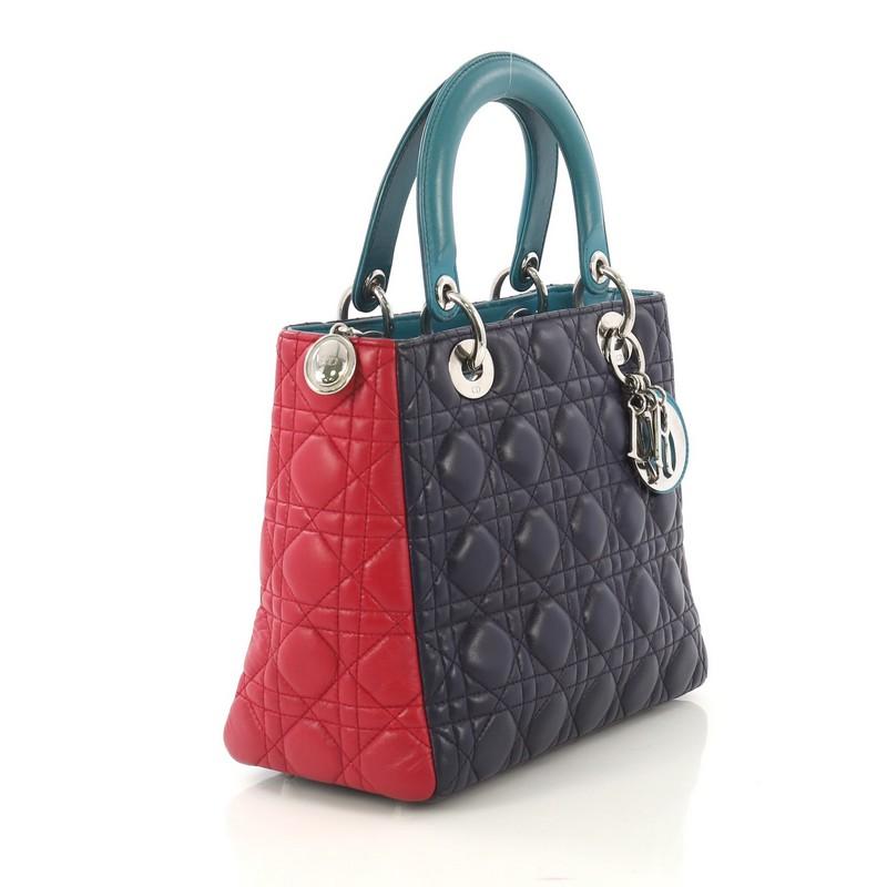 This Christian Dior Tricolor Lady Dior Handbag Cannage Quilt Leather Medium, crafted in purple, pink and teal cannage quilted leather, features dual top leather handles, Dior charms, protective base studs, and silver-tone hardware. Its zip closure