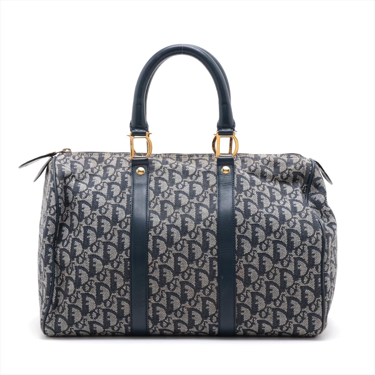 The Christian Dior Trotter Canvas Leather Boston Bag in Navy Blue is a luxurious and sophisticated accessory that embodies Dior's iconic design. Crafted from the signature Trotter canvas and complemented by navy blue leather trim, the bag exudes a