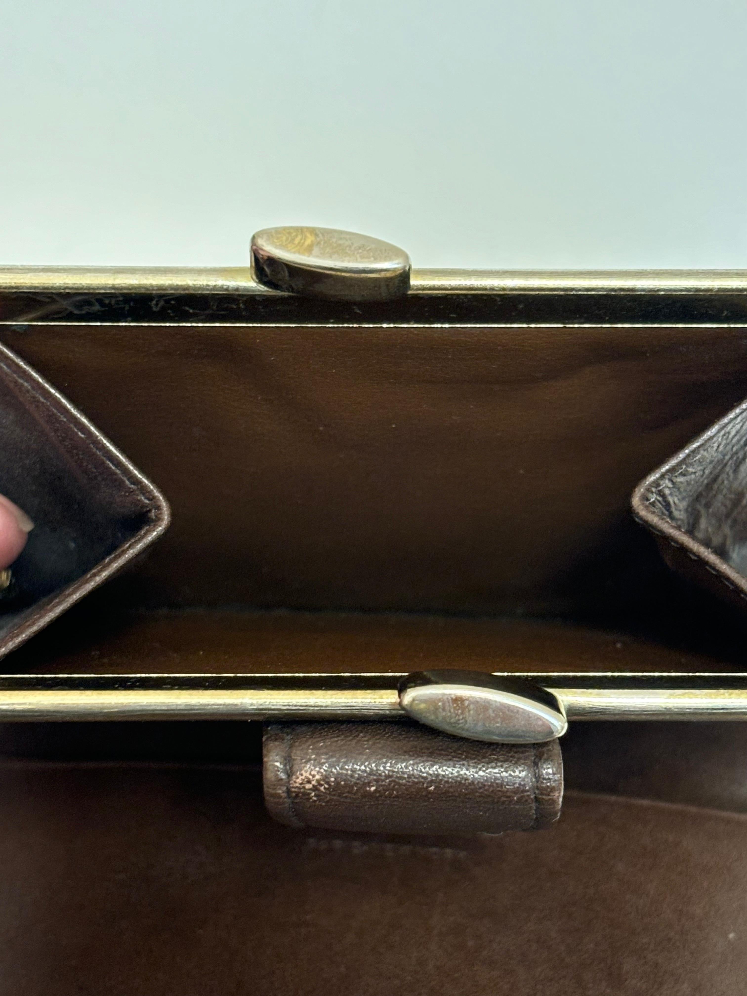 This is a very nice vintage wallet by Christian Dior with the well know trotter patter. This brown/beige wallet is made of canvas with leather trim. The wallet is very roomy, with three inside slots; a separate coin purse, as well as a kiss lock and