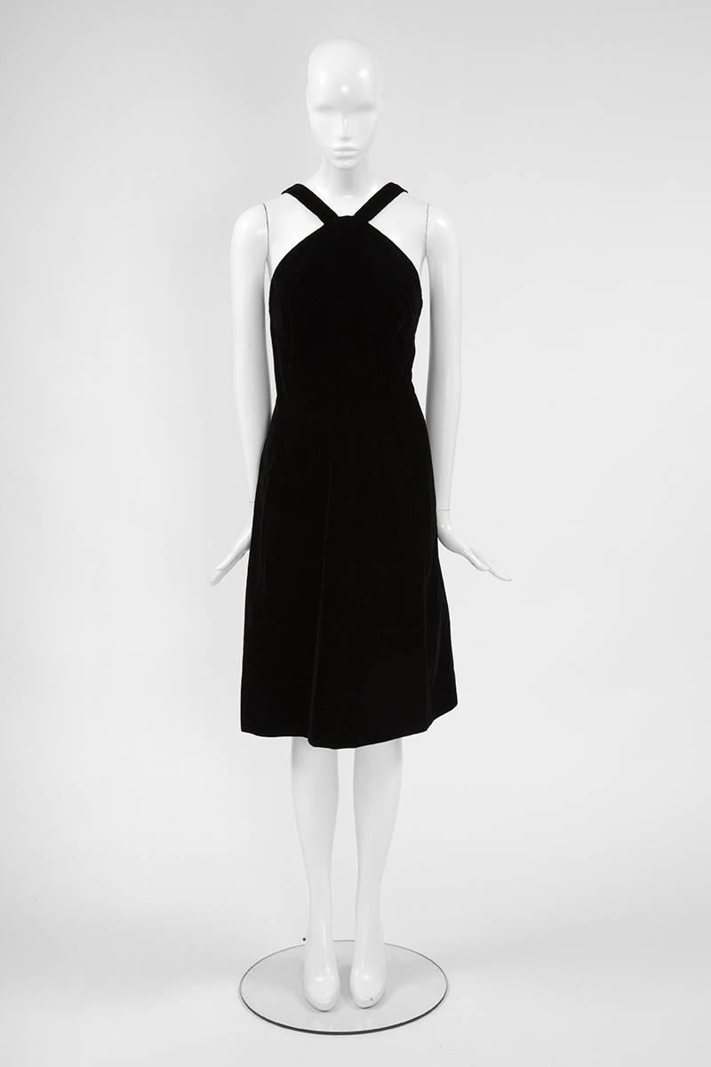 This elegant 60’s Dior boutique “little black dress” is a true classic for any modern wardrobe. Constructed in refined black velvet and featuring a faux crossover in the front, the dress skims the bust to create a flattering silhouette. The unusual