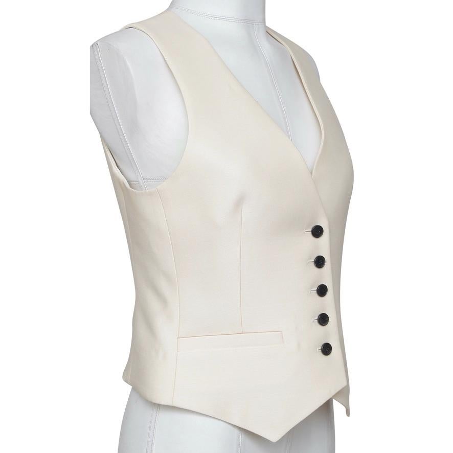 GUARANTEED AUTHENTIC DIOR ECRU FITTED VEST

Details:
• Sleeveless.
• Front button closure.
• Front darts.
• Pointed hem.

Fabric: 80% Wool, 20% Silk

Size: 38

Measurements (Approximate Laid Flat):
• Shoulder to Shoulder: 