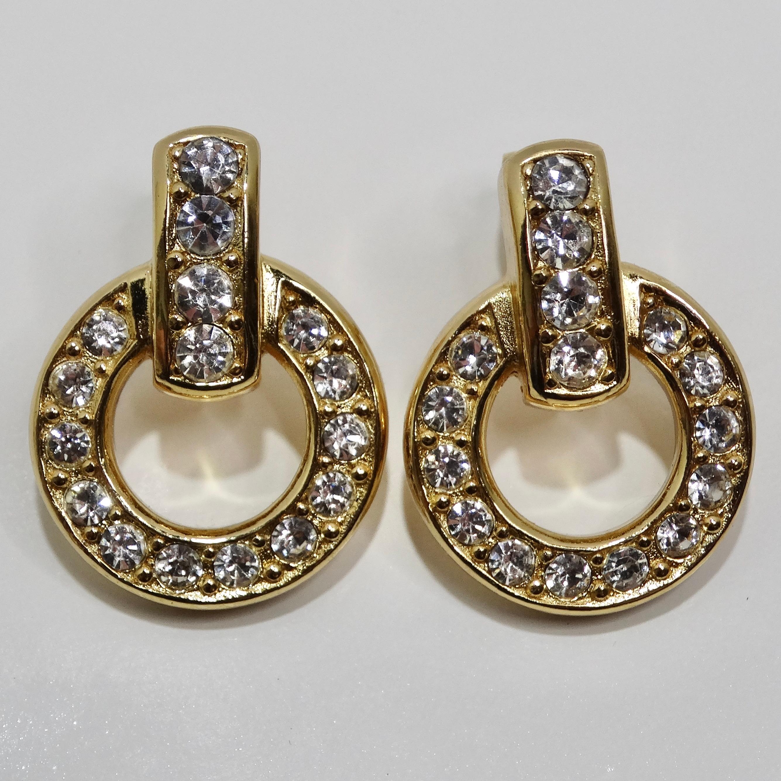 Introducing the Christian Dior Vintage 18K Gold Plated Rhinestone Earrings, a stunning pair of dangle earrings that exude glamour and timeless elegance. These vintage earrings feature a circle motif, elegantly adorned with sparkling rhinestones, all