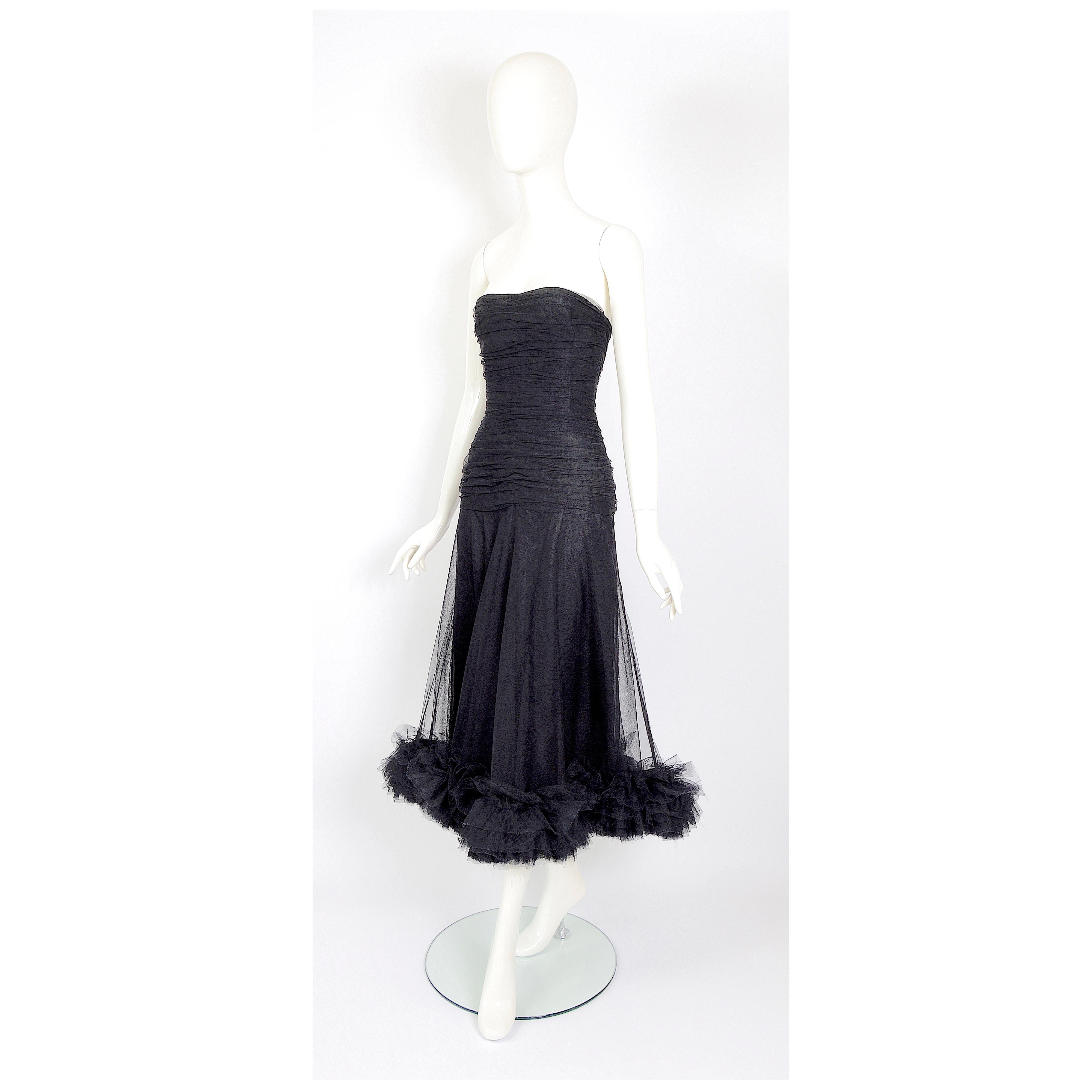 Christian Dior by Marc Bohan numbered couture black tulle dress.
Christian Dior, the founder of the fashion house passed away in 1957,  Marc Bohan succeeded Yves Saint Laurent in 1960.
A strapless drop-waist sheath of horizontally gathered black