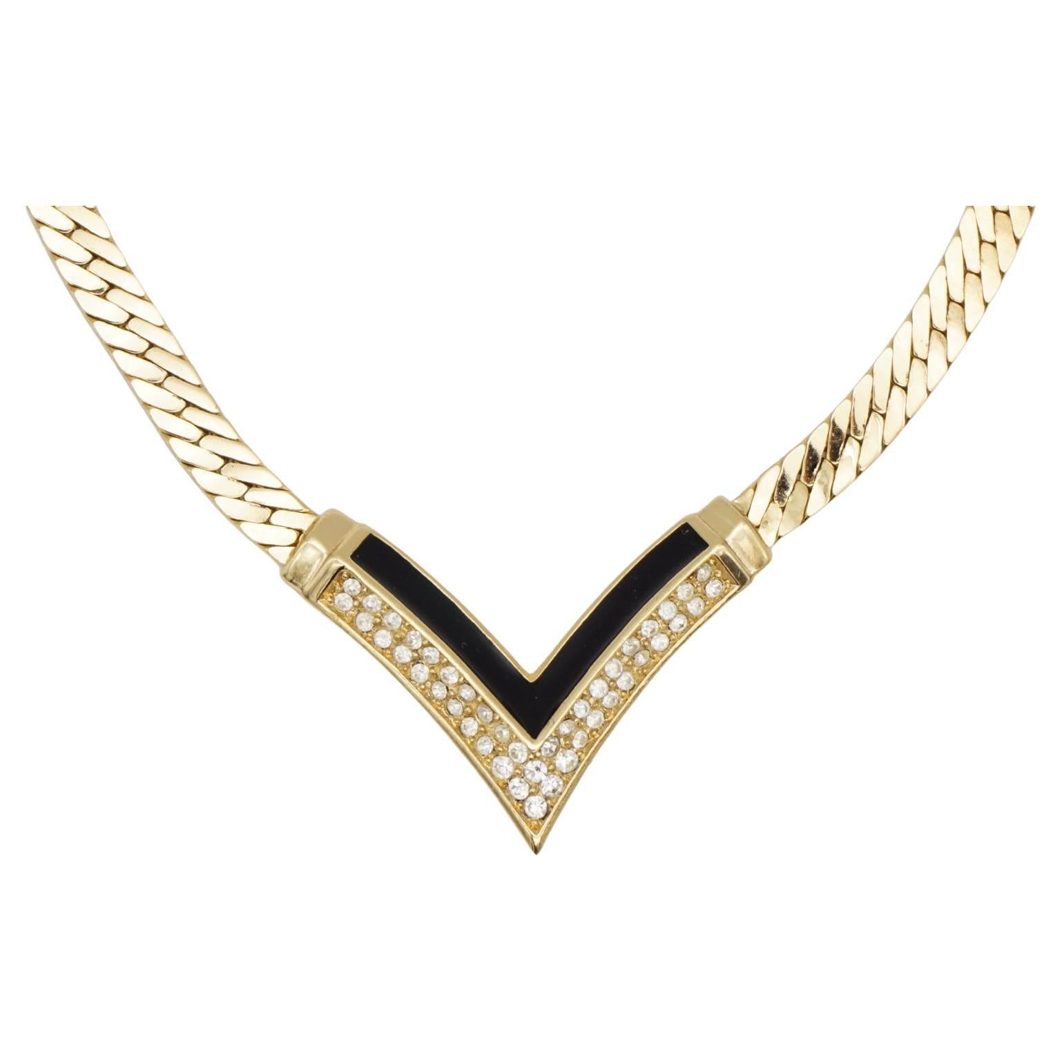 Christian Dior Vintage 1970s Black Enamel Crystals Arrow Triangle Pendant Necklace, Gold Tone

Very good condition. 100% Genuine. Marked 'Chr.Dior (C) '

It is around 50 years old. This is a very stylish and rare piece of jewellery.

Length: 34 cm.