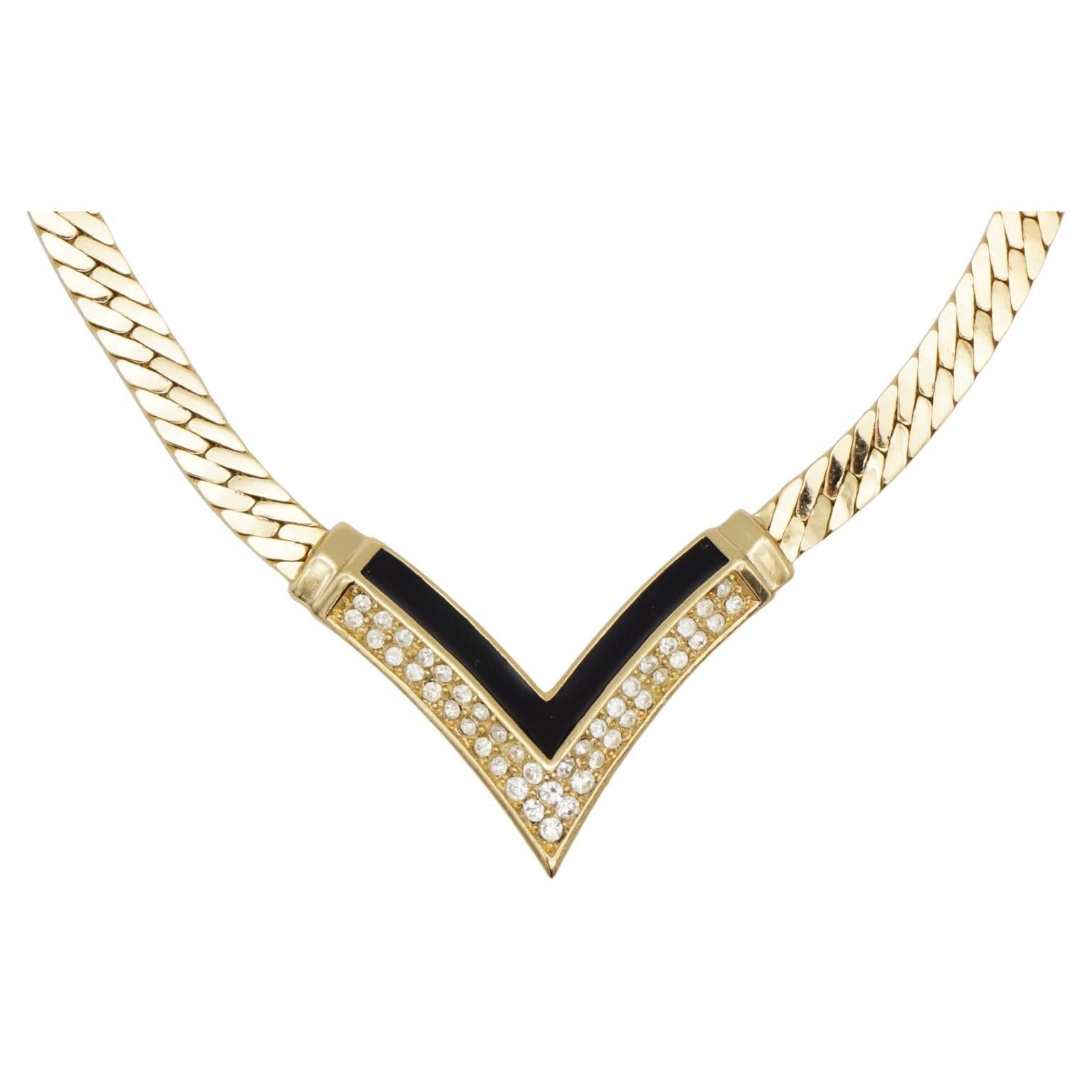 Christian Dior Vintage 1970s Black Enamel Crystals Arrow Triangle Pendant Necklace, Gold Tone

Very good condition. 100% Genuine. Marked 'Chr.Dior (C) '

It is around 50 years old. This is a very stylish and rare piece of jewellery.

Length: 34 cm.